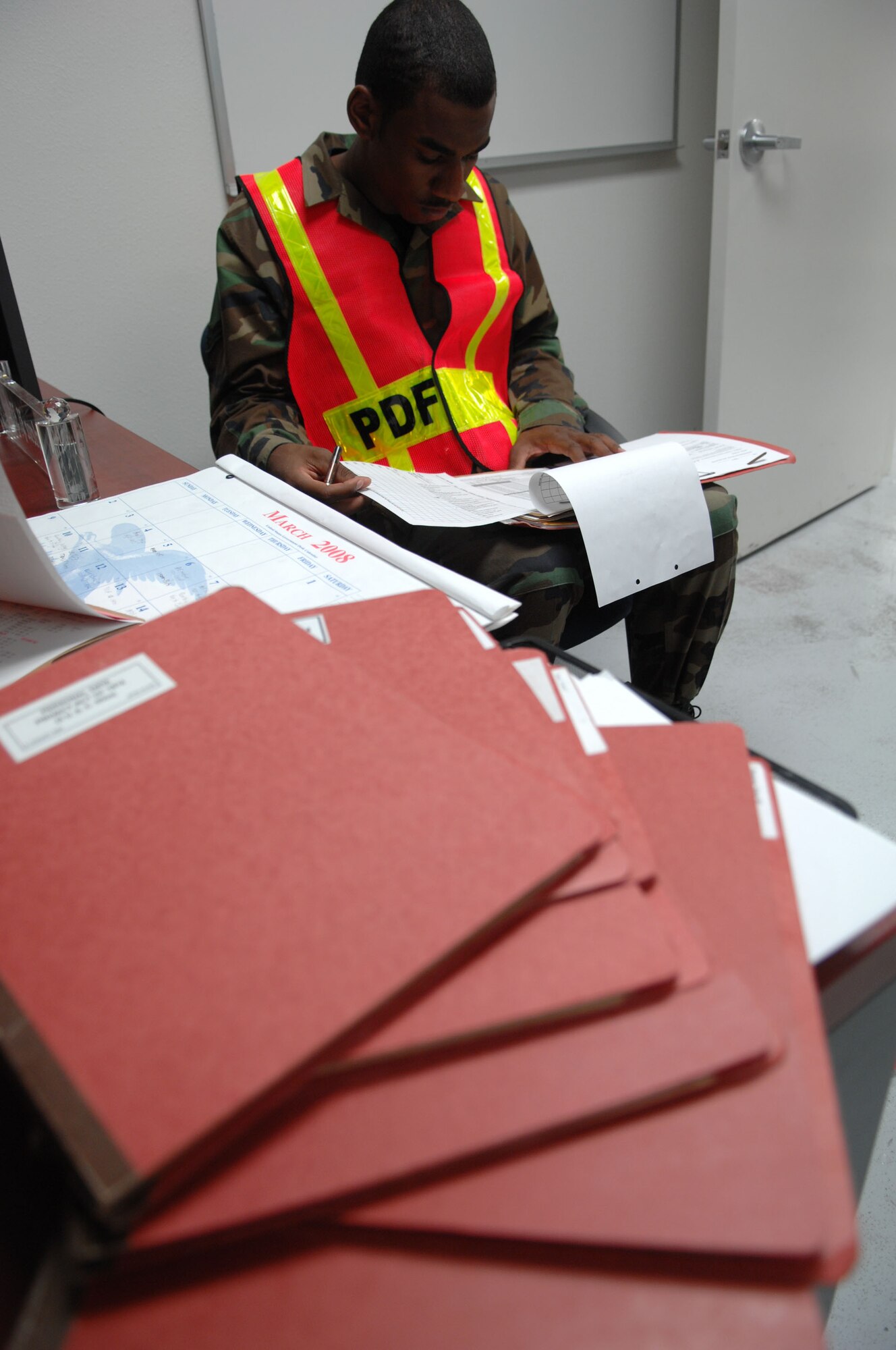 Airman 1st Class Sean Cooper reviews Airman’s records before they enter the Deployment Processing Center during Exercise Coronet Gold Rush 08-02, March 26, 2008, Holloman Air Force Base, N.M.. 
(U.S. Air Force photo/Senior Airman Anthony Nelson Jr)