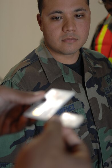 Airman 1st Class Sean Cooper checks Staff Sgt Braulio Jimenez’s Common Access Card and Dog tags before entering the briefing room of the Deployment Processing Center during Exercise Coronet Gold Rush 08-02, March 26, 2008, Holloman Air Force Base, N.M..
(U.S. Air Force photo/Senior Airman Anthony Nelson Jr)