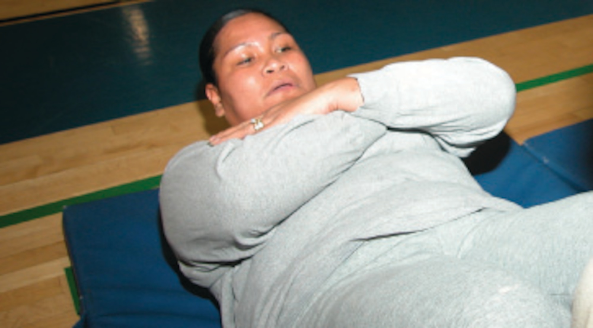 Sgt. AsoivaThomsen, 304th Sustainment Brigade, successfully completes her sit-ups. She was the second place winner in the women’s category in the Fit to Fight push-up and sit-up competition at March Air Reserve Base, Calif.  (U.S. Air Force photo by Staff Sgt. Joe Davidson)