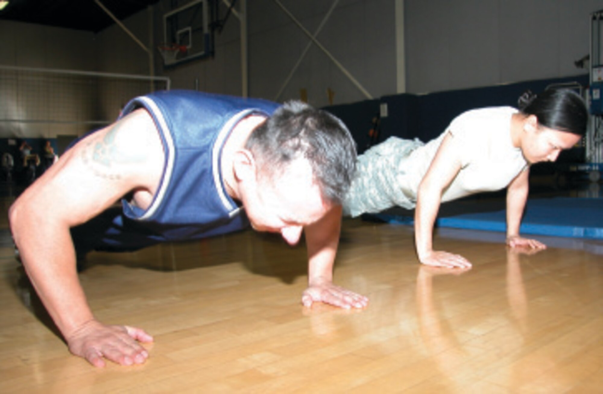 Master Sgt. Ruben Negrette, 163rd Reconnaissance Wing and Army Specialist Cat Mai, 304th Sustainment Brigade are the first place winners in the Fit to Fight push-up and sit-up competition at March Air Reserve Base, Calif.  (U.S. Air Force photo by Staff Sgt. Joe Davidson)
