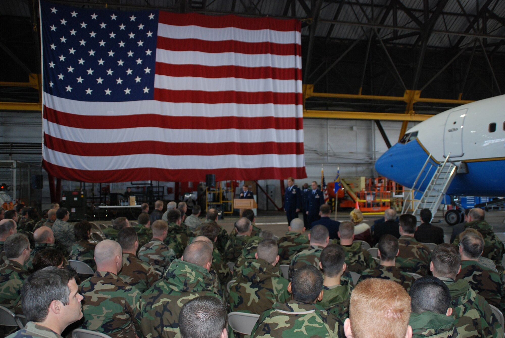 Maj. Clifford Waller becomes the 932nd Maintenance Squadron's new commander underneath the American flag at the 932nd Airlift Wing. Major Waller assumed command at the March unit training assembly. The nose of a C-40C aircraft is seen at right.  Photo/Tech. Sgt. Dan Oliver
