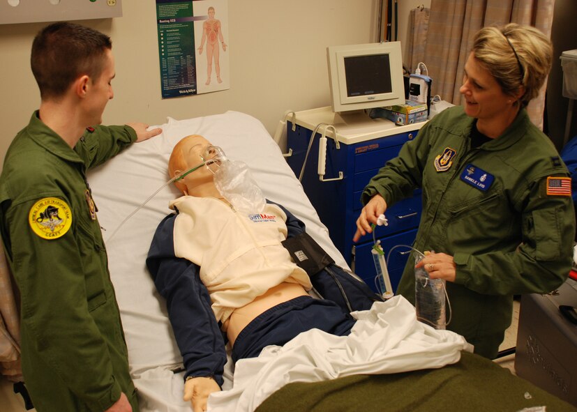 Before heading overseas on an AEF deployment, 932nd Medical Group member Staff Sgt. Brett Anderson and Capt. Danielle Loyd practiced lifesaving skills on a simulationman robotic patient in the 932nd Medical Group building.  Photo/Capt. Stan Paregien