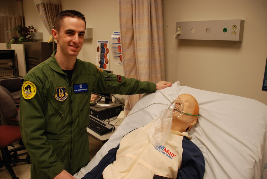 Checking the oxygen mask on his "patient" during a training session is Staff Sgt. Brett Anderson.  Before heading overseas on an AEF deployment, 932nd Medical Group member Staff Sgt. Brett Anderson practiced lifesaving skills on a simulation man robotic patient in the 932nd Medical Group building. Photo/Capt. Stan Paregien