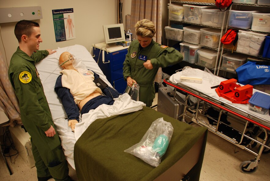 Is he having a real problem?  What does the patient's monitor say?  One of the greatest advantages of technology is having the opportunity to try something in the "virtual world" before trying it in the real world.  Before heading overseas on an deployment, 932nd Medical Group member Staff Sgt. Brett Anderson and Capt. Danielle Loyd practiced lifesaving skills on a "Sim-man" or simulationman robotic patient, in the 932nd Medical Group building.  Many medical symptoms can be programmed into the robot so that the training becomes very lifelike to the medical personnel.  They are members of the 932nd Airlift Wing, part of the Air Force Reserve Command.  Photo/Capt. Stan Paregien 