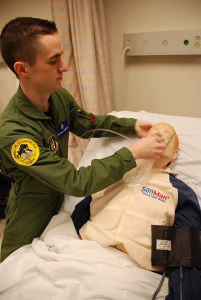 Before heading overseas on an AEF deployment, 932nd Medical Group member Staff Sgt. Brett Anderson practiced lifesaving skills on a simulation
man robotic patient in the 932nd Medical Group building.  Photo/Capt. Stan Paregien