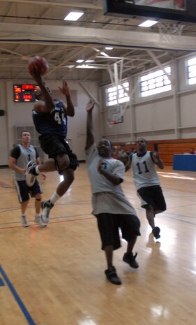 Lamar Hancock, SVS, shoots a layup over Anderson Nanton, APS, during the game Tuesday. (U.S. Air Force photo/Senior Airman Sam Hymas)