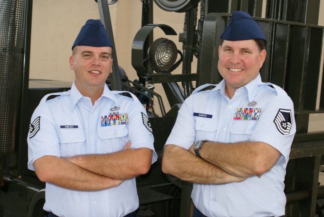 Tech. Sgt. Chad Ehrlich (left) and Master Sgt. Arthur Kuertz (right), 70th Aerial Port Squadron, led police to an individual seen on a wanted poster at the Miami International Airport on March 4. The reservists were on a temporary duty assignment as official greeters to transport distinguished visitors to and from the airport to the Air Force Reserve Command Mission Support Group Conference at Homestead Air Reserve Base during the week of March 3-7. (U.S. Air Force photo/Senior Airman Erik Hofmeyer)