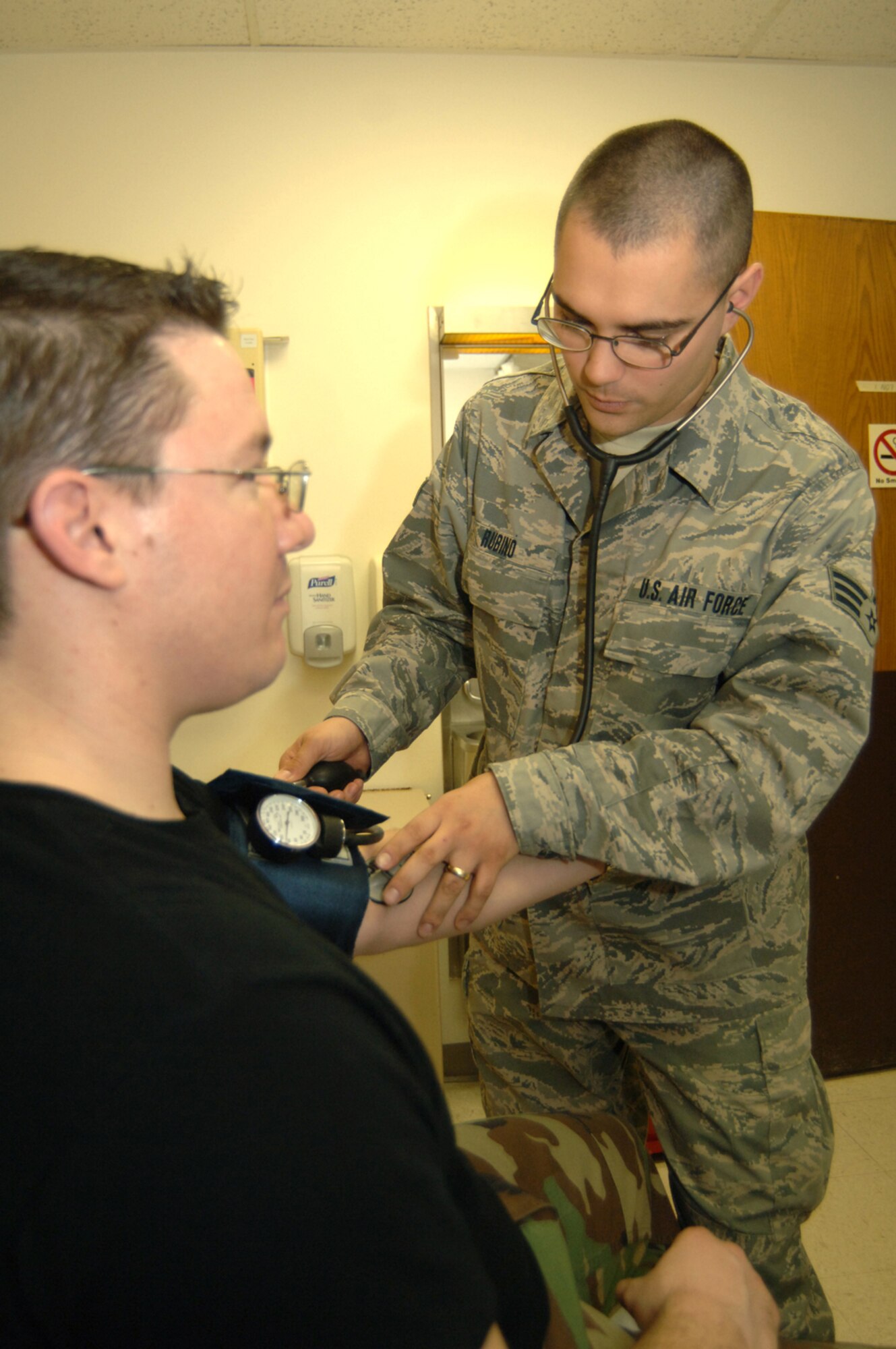 Senior Airman Ryan Rubino, 55th Medical Operations Support Squadron, checks a patient's blood pressure at the Ehrling Bergquist Clinic's Urgent Care Center. Beginning, April 1, the UCC will become an appointment-only acute care clinic. Appointments can be made by calling 232-CARE. For emergency care, patients should call 911 or report immediately to their nearest emergency room. (U.S. Air Force Photo/Tech. Sgt. Rhonda Moraski)