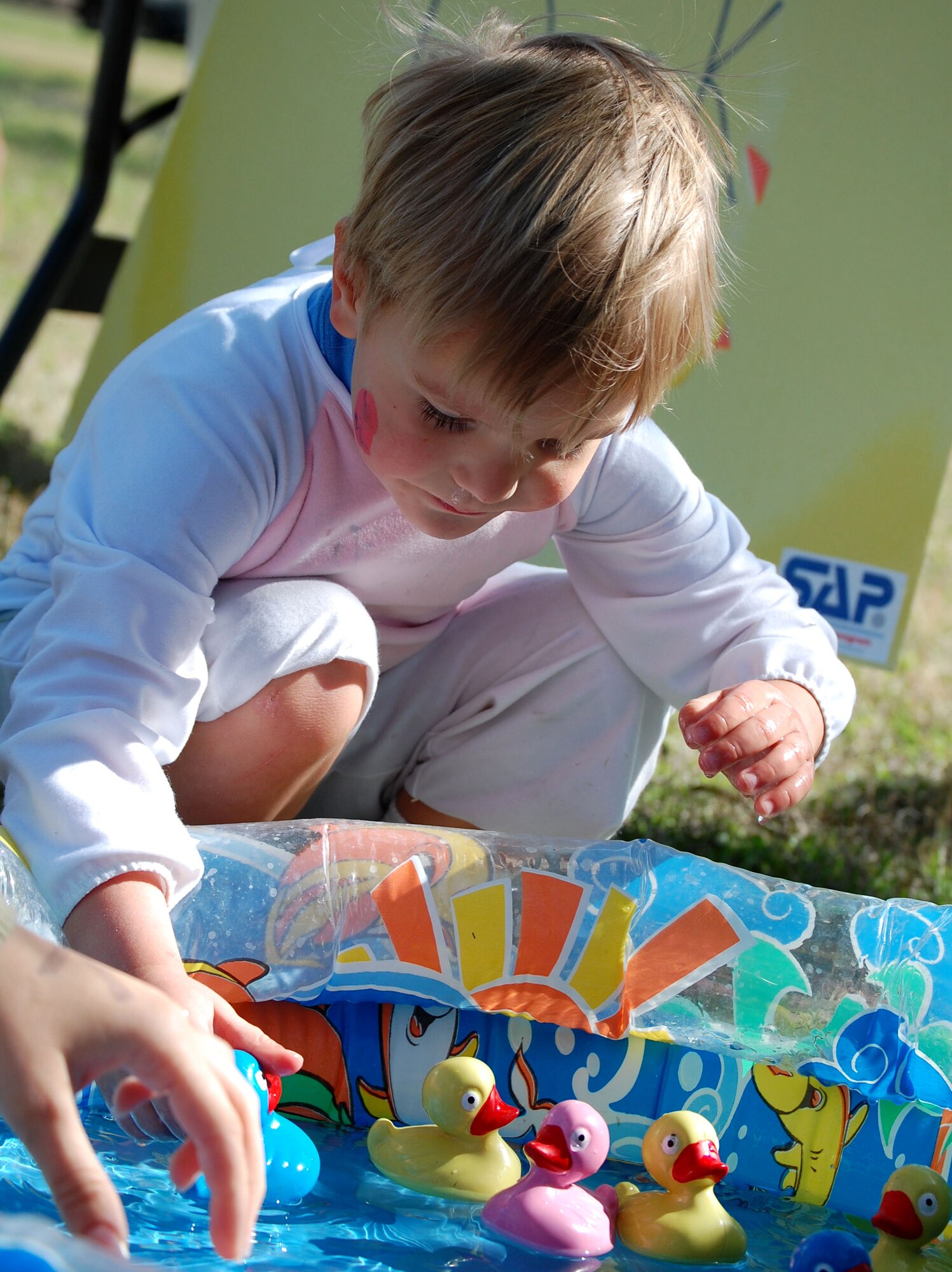 LAUGHLIN AIR FORCE BASE, Texas – Matthew Thompson, 3, son of Steve Thompson, U. S. Air Force retired, and Holly Thompson, carefully chooses a numbered rubber ducky from the duck pond in order to win a prize at Laughlin Youth Center’s Annual Spring Family Day March 22. The family day began with a parade that ran from the base chapel to the picnic grounds and continued with an egg hunt and other family oriented games. “We estimate there were nearly 500 individuals that came to the event,” said Ray Torres, Youth Center director. (U.S. Air Force photo by Airman Sara Csurilla)