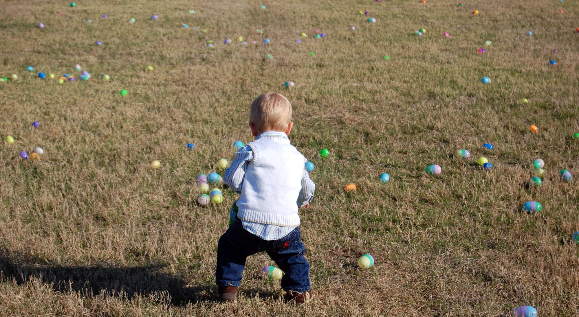 LAUGHLIN AIR FORCE BASE, Texas – A young boy gets a head-start on the egg hunt during Laughlin Youth Center’s Annual Spring Family Day March 22. “In over five years of working youth programs and base-wide events, this has to be one of the smoothest events we ever coordinated!  Lots of people, fun games, great weather, awesome volunteers, tasty food; things just fell into place,” said Ray Torres, Youth Center director. (U.S. Air Force photo by Airman Sara Csurilla)