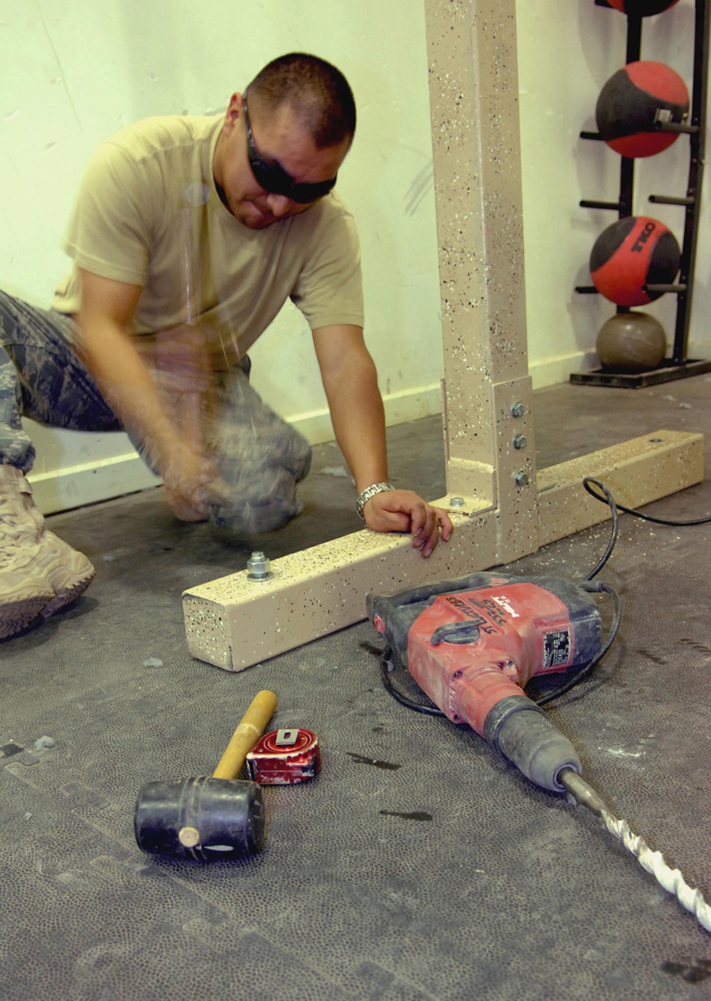 Staff Sgt. Gabriel Lira, 332nd Expeditionary Civil Engineer Squadron structural engineer, screws in the floor boards of a new pavilion in Balad’s Housing 6 area, March 19. The pavilion will offer servicemembers a place to drink coffee, read and socialize. Since their arrival, the deployed 21st Civil Engineer Squadron members have poured 1,894 cubic meters of concrete to increase aircraft parking and maintenance space on the base’s flightline. The Airmen have also enabled the fixed/rotary wing hot pit areas for multiple weapons systems and bolstered close air support by 20 percent. They have also completed taxiway repairs, conducting 386 small repairs to prevent combat sortie delays. They have also built a 4,000 square-foot concrete pad for a munitions storage area, foreign object and debris checkpoint, reducing FOD hazards by 73 percent to safeguard $1.9 million in assets. Currently, the members are working on projects to increase the unmanned aerial vehicle footprint in this area of responsibility. Sergeant Lira is deployed from Peterson Air Force Base, Colo. (U.S. Air Force photo)