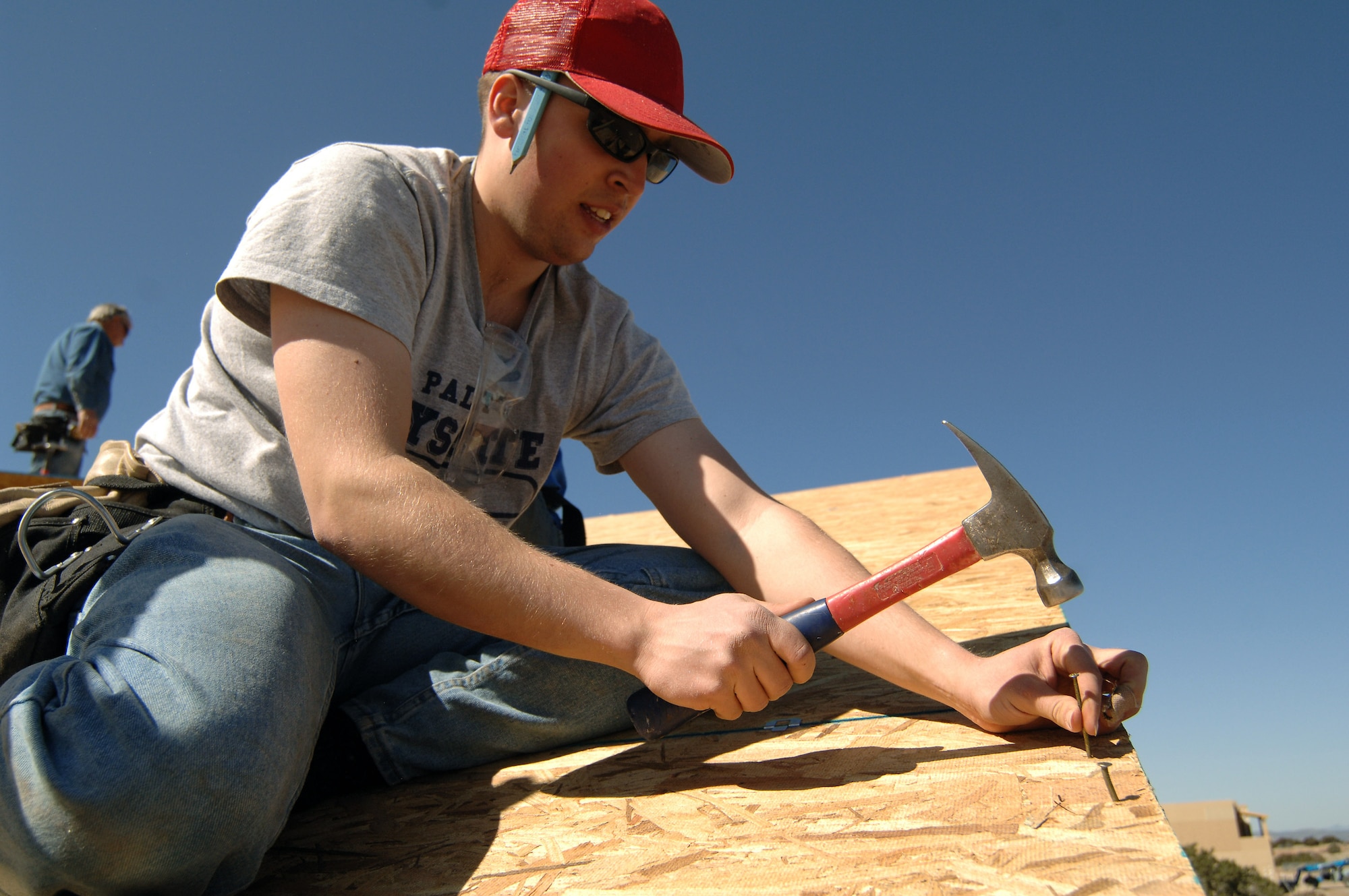 Cadet 3rd Class Nate Moeller, Cadet Squadron 1, works on the roof of a Habitat for Humanity home. Cadet Moeller is one of 65 Air Force Academy cadets giving up their spring break this week, to build homes for the needy in Santa Fe, N.M.; Cody, Wyoming; El Paso, Texas; and Beaumont, Texas. (U.S. Air Force photo/John Van Winkle)  