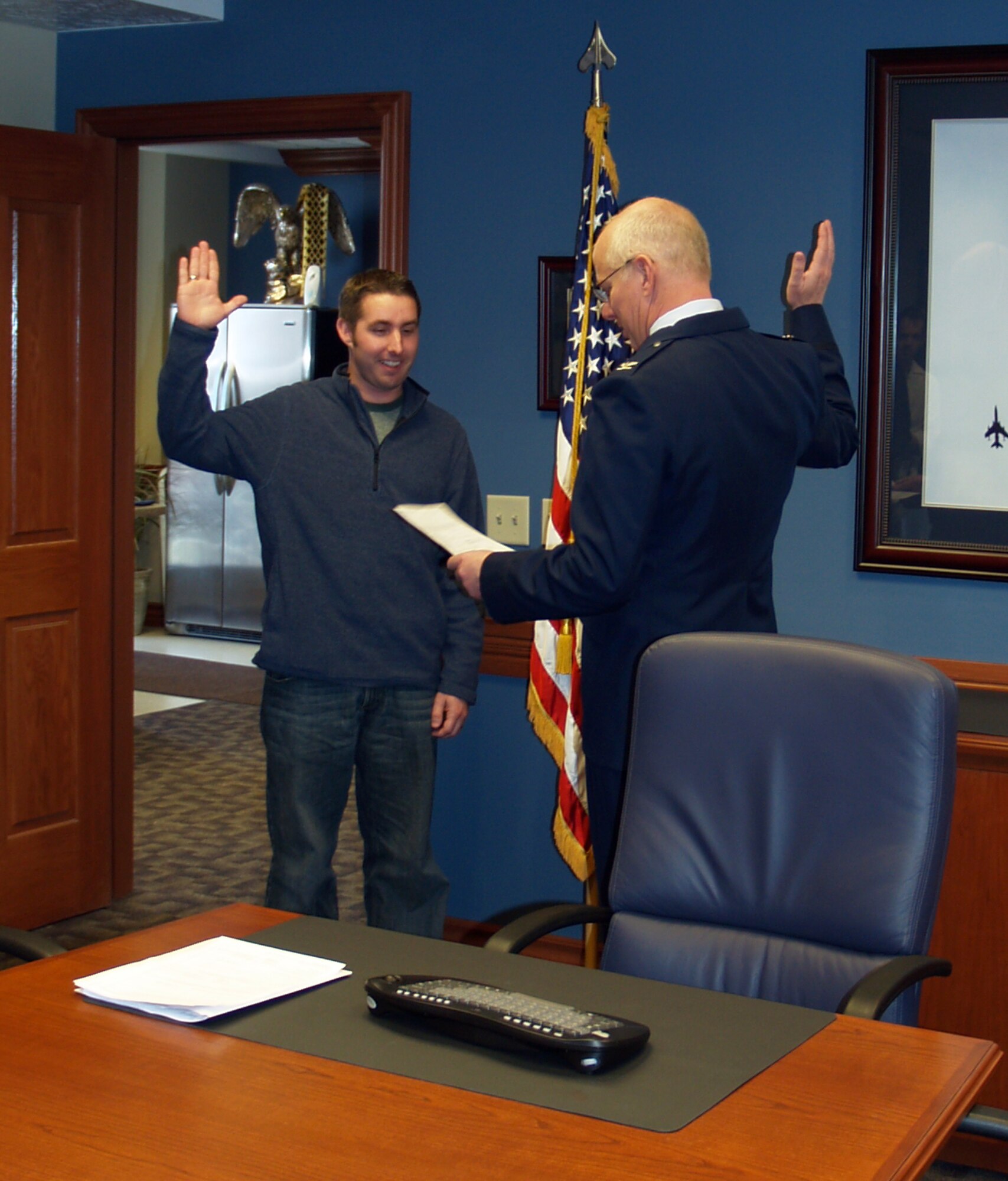 Col. (Ret.) James Robinson swears in his son-in-law, Andrew Potter, in the 419th Fighter Wing conference room March 17. Potter will be joining the 67th Aerial Port Squadron after attending basic training and tech school in Texas. The Air Force Reserve encourages its members to recommend names of potential recruits through the Get One Now program. The program allows Reservists to have a say in who joins, and rewards those who refer friends and family with commemorative coins and other accession awards. Members can submit referrals on the Web at get1now.us, or call 877-786-2372. 