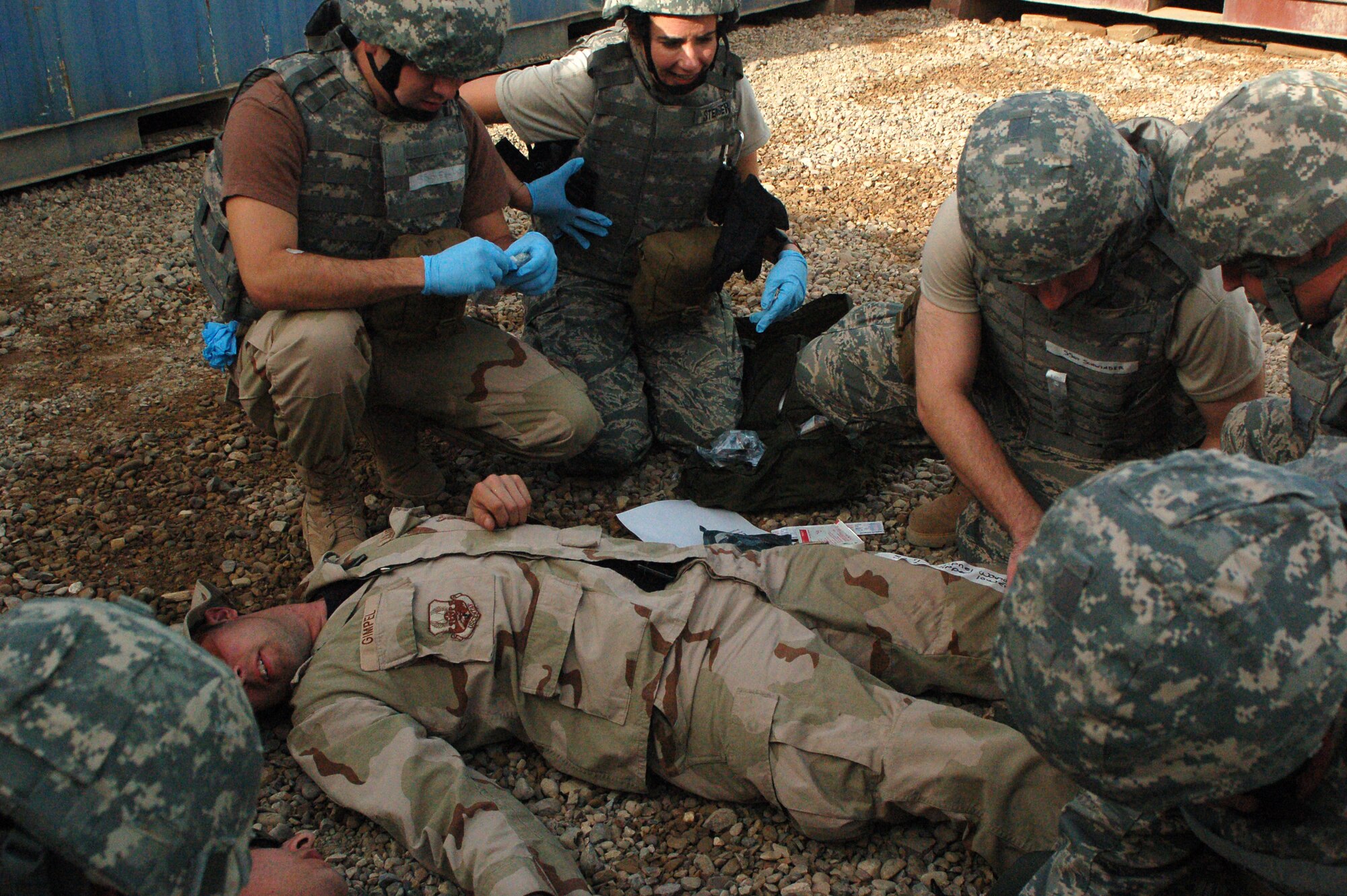 SATHER AIR BASE, Iraq -- A team of newly trained non-clinical medical personnel from the 447th Expeditionary Medical Squadron practice their newly gained skills after a recent training session here. The "medics" are actually in career fields not normally expected to perform medical procedures, but in a combat zone, it is important for these Airmen in the clinic to be able to assess and help with procedures, freeing up more time for the doctors to concentrate on the seriously injured. (U.S. Air Force photo/Tech. Sgt. Amanda Callahan)