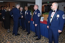 MINOT AIR FORCE BASE, N.D. -- (left) Col. Marty Whelan, 91st Space Wing commander, congratulates Airmen upon making the rank of Chief Master Sergeant during a ceremony at the Jimmy Doolittle Center here March 22. Six Airmen here made the cut to the enlisted force's highest rank. (U.S. Air Force photo by Senior Airman Cassandra Jones)