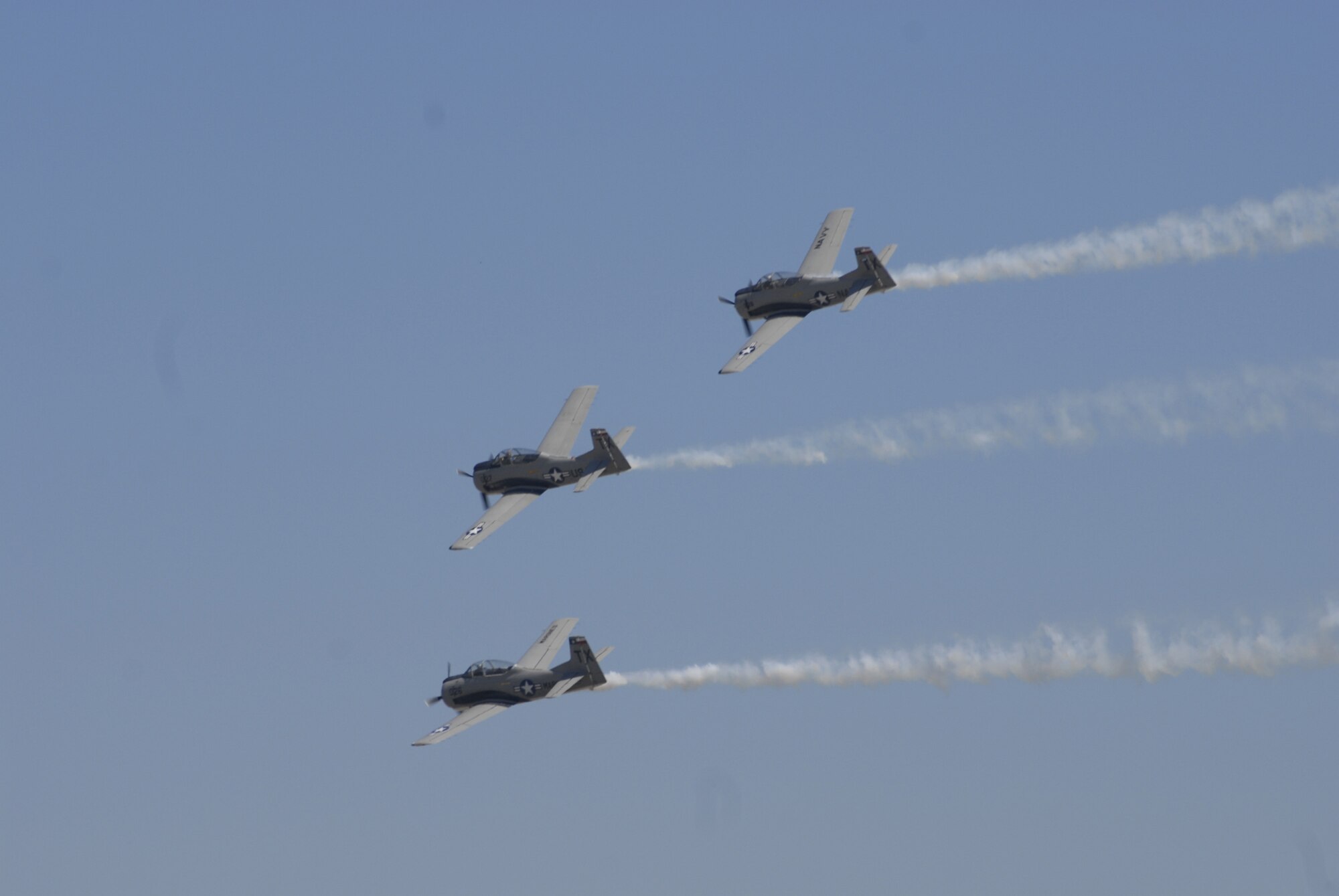 Three T-28 Trojans, marked with Air Force, Marine Corps and Navy insignia, fly in formation during Air Fiesta ’08 March 15. The air show played host to a large variety of heritage aircraft. (U.S. Air Force photo by Senior Airman Kamaile Chan)