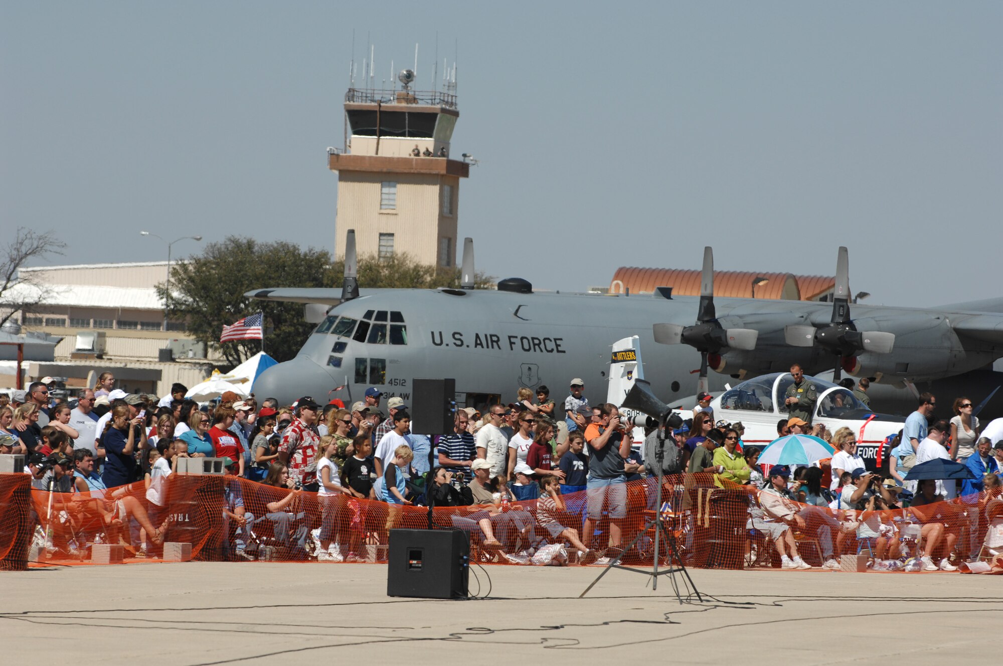 Crowds at the air show March 15 gather in front of a C-130 Hercules (larger aircraft) and a T-37 Tweet (smaller aircraft). (U.S. Air Force photo by Staff Sgt. John Barton)