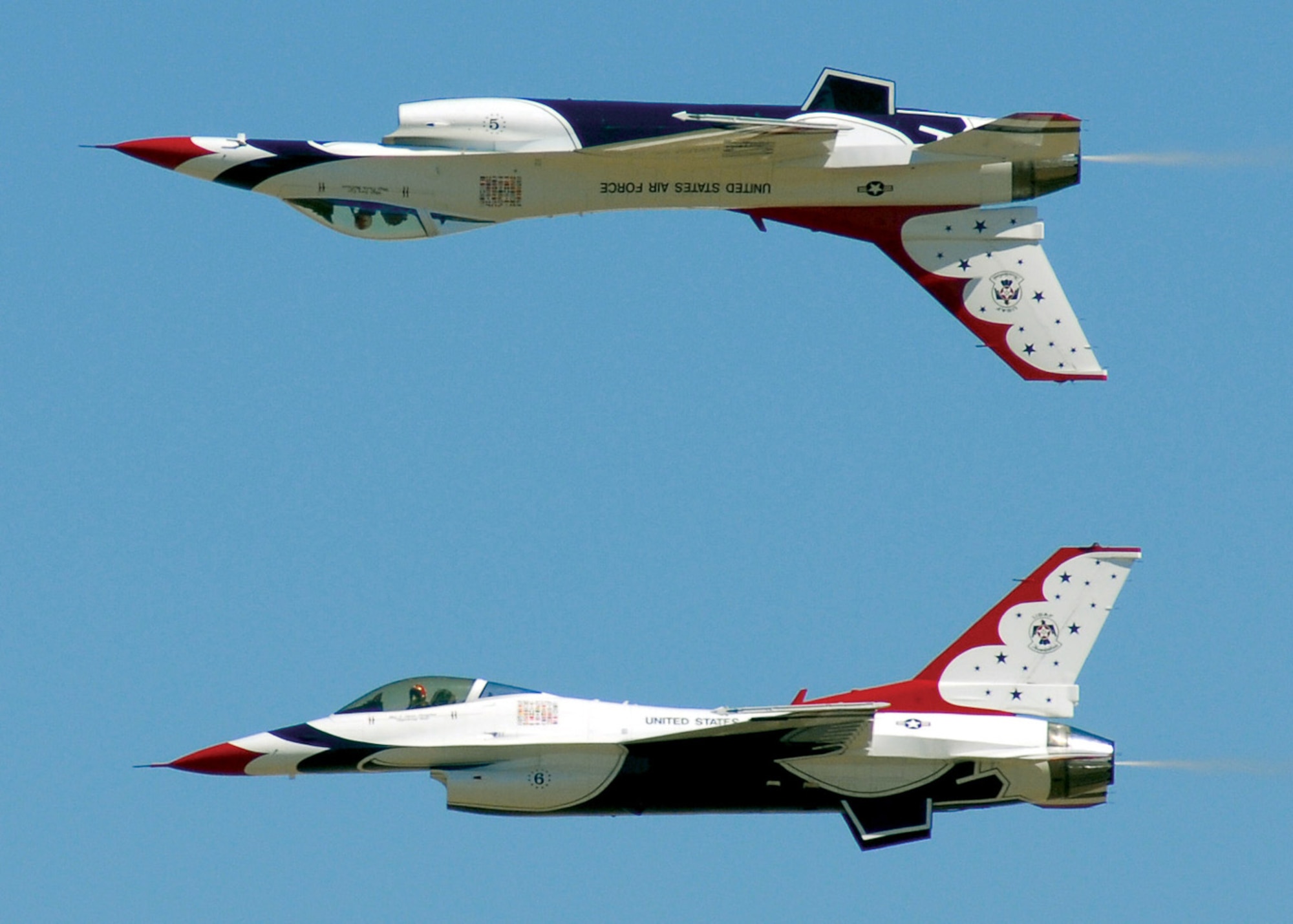 Major Samantha Weeks (Thunderbird 5, upside down) and Maj. T. Dyon Douglas (Thunderbird 6) pass over Air Fiesta ‘08, March 15 at San Angelo Regional Airport Mathis Field. The 5 on Maj. Week’s F-16 Fighting Falcon, as well as her uniform, is inverted - when the number is viewed right side up, it means the lead solo pilot is in her natural state: flying upside down. (U.S. Air Force photo by Staff Sgt. Angela Malek)