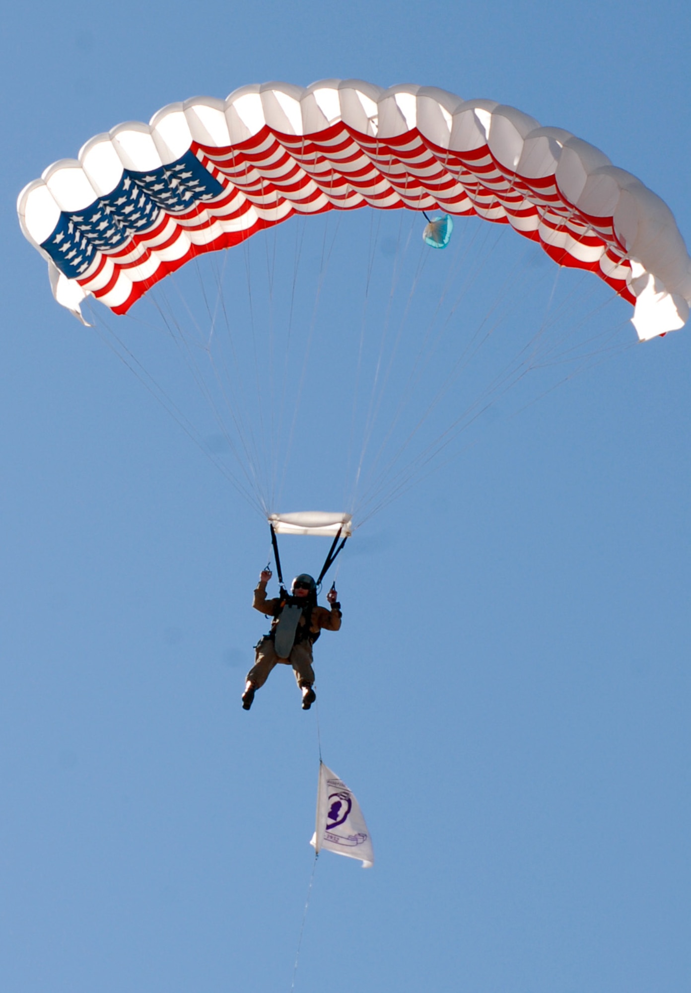 Dallas Whittgenfeld, a member of the Liberty Jump Team, parachutes from a C-47 Gooney Bird during the playing of the National Anthem. (U.S. Air Force photo by Staff Sgt. Angela Malek)