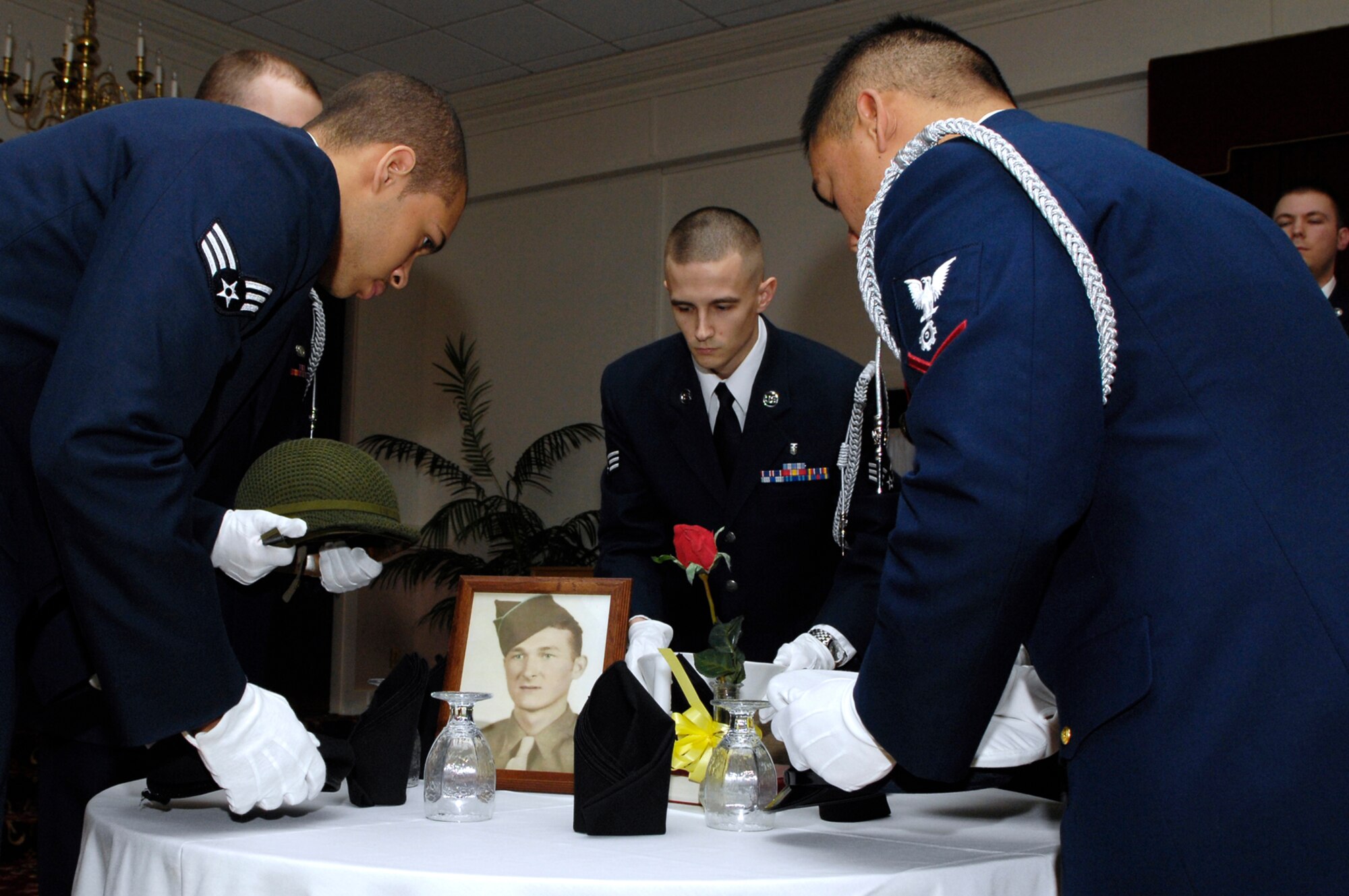 HANSCOM AFB, Mass. -- Students from Airman Leadership School participate in a Prisoner of War, Missing in Action ceremony during an ALS Graduation March 21 held at the Minuteman Club. Eleven students graduated from ALS during the ceremony. ALS is a five-week course and the first step of Professional Military Education for all enlisted Airmen. The course is required to be taken in residence by active-duty servicemembers prior to being promoted to the rank of staff sergeant and is a requirement for all Airmen to be a rater on Enlisted Performance Reports. (U.S. Air Force photo by Mark Wyatt.)   