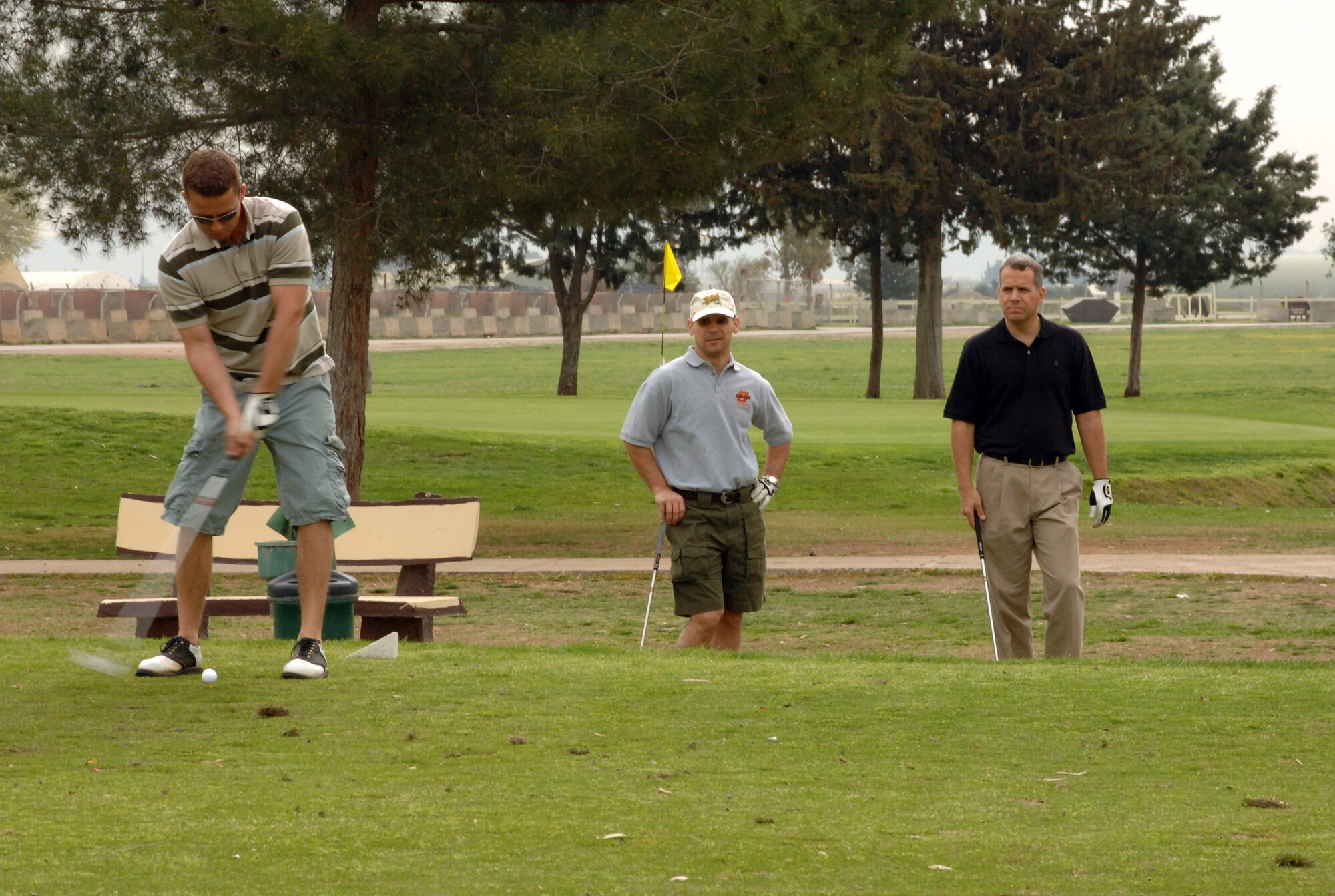 Capt. Jonathan Richeson, 39th Security Forces Squadron, tee’s off during the “Timmy Gatherum Golf Tournament” March 22 at the Hodja Lakes Golf Course, while Col. Keneth Stefanek, 39th Air Base Wing vice commander, and Col. John Taylor, 39th Maintenance Group commander, watch. (U.S. Air Force Photo by Senior Airman Jason Burton)