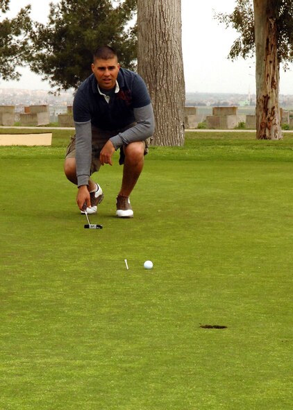 Robert Alessi, 39th Security Forces Squadron military working dog handler, lines up his shot during the “Timmy Gatherum Golf Tournament” March 22 at the Hodja Lakes Golf Course. More than 100 members of Team Incirlik participated in the tournament and were able to raise approximately  $4,000. The tournament was designed to help Sergeant Gatherum’s family offset the cost of traveling expenses and time off from work. (U.S. Air Force Photo by Senior Airman Jason Burton)