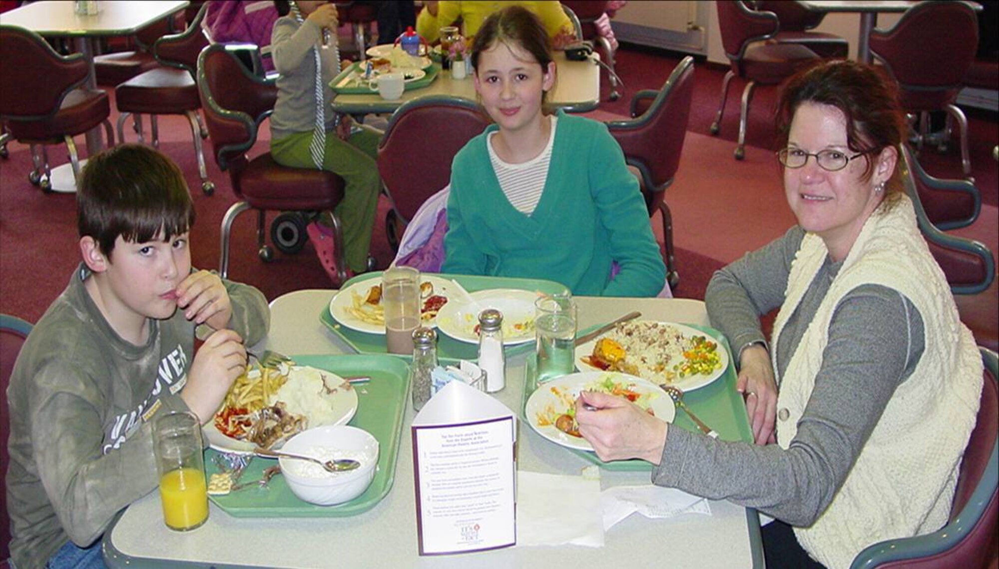 Liza Torpy, spouse of Mr. Brent Torpy who is deployed, enjoys a free dinner provided by the Airman and Family Readiness Center at Spangdahlem Air Base, along with son Alex and daughter Jacqueline.  Monthly dinners for families of depoyed members are planned for the second Thursday of each month at the base.
