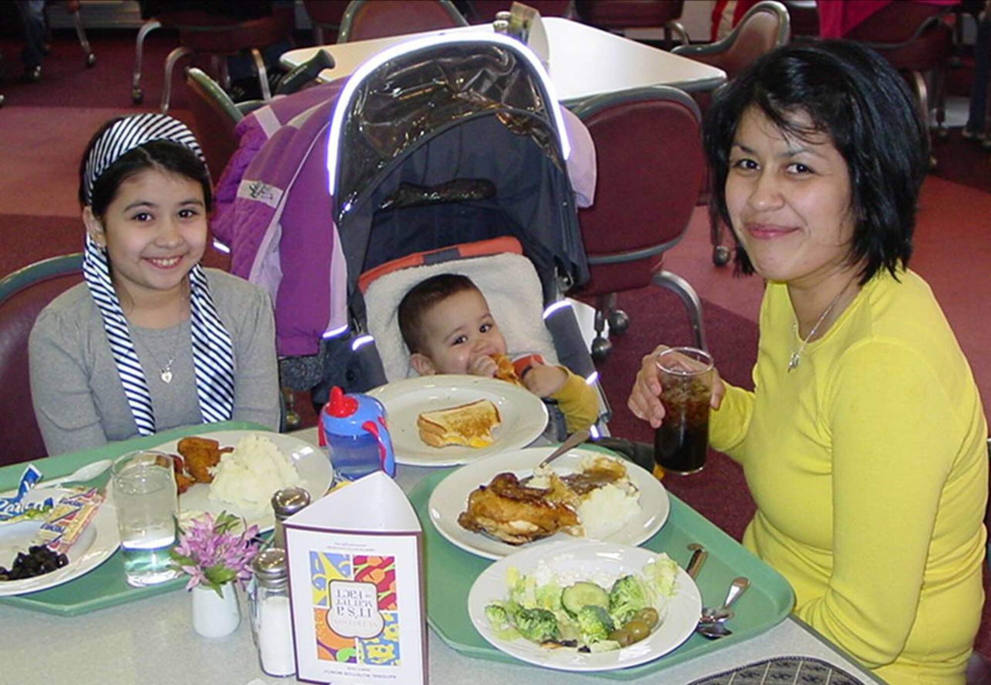 April Breakfield, spouse of Capt Michael Breakfield who is deployed, enjoys a free dinner provided by the Airman and Family Readiness Center at Spangdahlem Air Base, along with son Liam and daughter Skyler.  Monthly dinners for families of depoyed members are planned for the second Thursday of each month at the base.