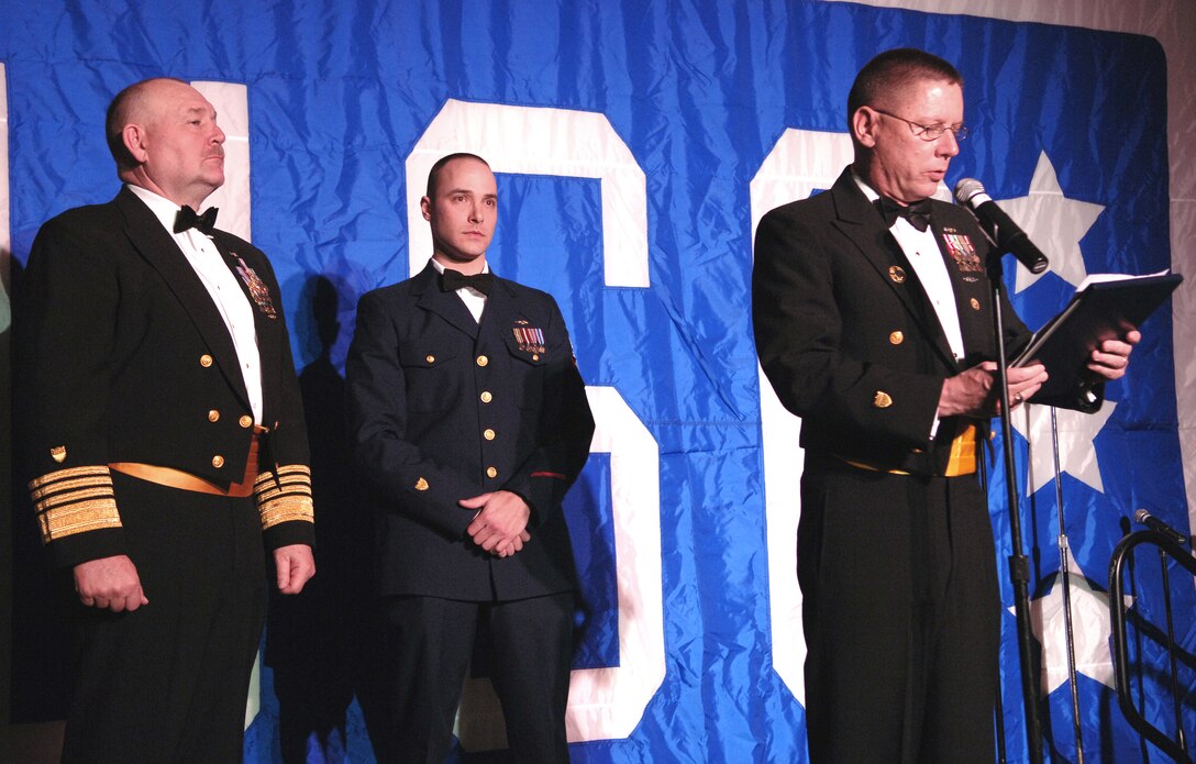 Master Chief Petty Officer of the Coast Guard Charles W. Bowen reads an Air Medal citation for Aviation Survival Technician 2nd Class Erick A. Lieb, center, while Coast Guard Commandant Thad Allen listens during the USO Metro awards in Arlington, Va., March 25, 2008. Lieb, a Coast Guard swimmer, was instrumental in saving numerous people following Hurricane Katrina. 