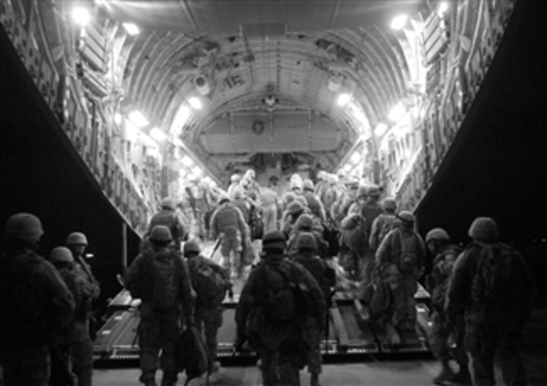 U.S. Navy Seabees assigned to Naval Mobile Construction Battalion 17, better known as the "Desert Battalion," board a U.S. Air Force C-17 aircraft bound for Anbar Province, Iraq, March 19, 2008.