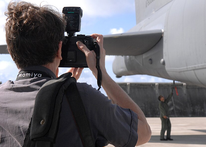 Andersen Air Force Base, Guam - Mr. Greg Girard, a photographer with Time Magazine
takes pictures of a 393rd Expeditionary Bomb Squadron aircrew member performing a pre-flight inspection on a B-52 Stratofortress March 26th on Andersen AFB, Guam. The photographer is shooting photos for an article about life on U.S. bases in Asia. Mr. Gerard has traveled all over Asia and hopes to create a series of photographs that will serve as a record of these uniquely American places and of the people who live and work around them. The 393rd EBS is deployed from Barksdale AFB, La. (U.S. Air Force photo/Staff Sgt. Vanessa Valentine)

