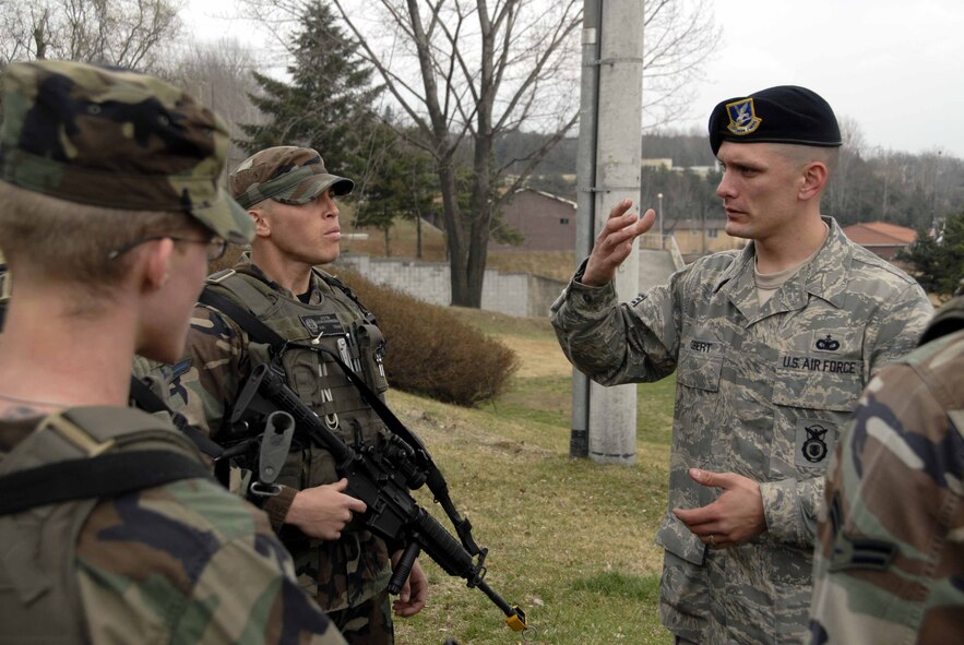 OSAN AIR BASE, Republic of Korea -- Staff Sgt. Jack Gilbert, 51st Security Forces Squadron, instructs security forces Airmen on range determination and how distance affects bullet range. (U.S. Air Force photo/Senior Airman Christopher Boitz)