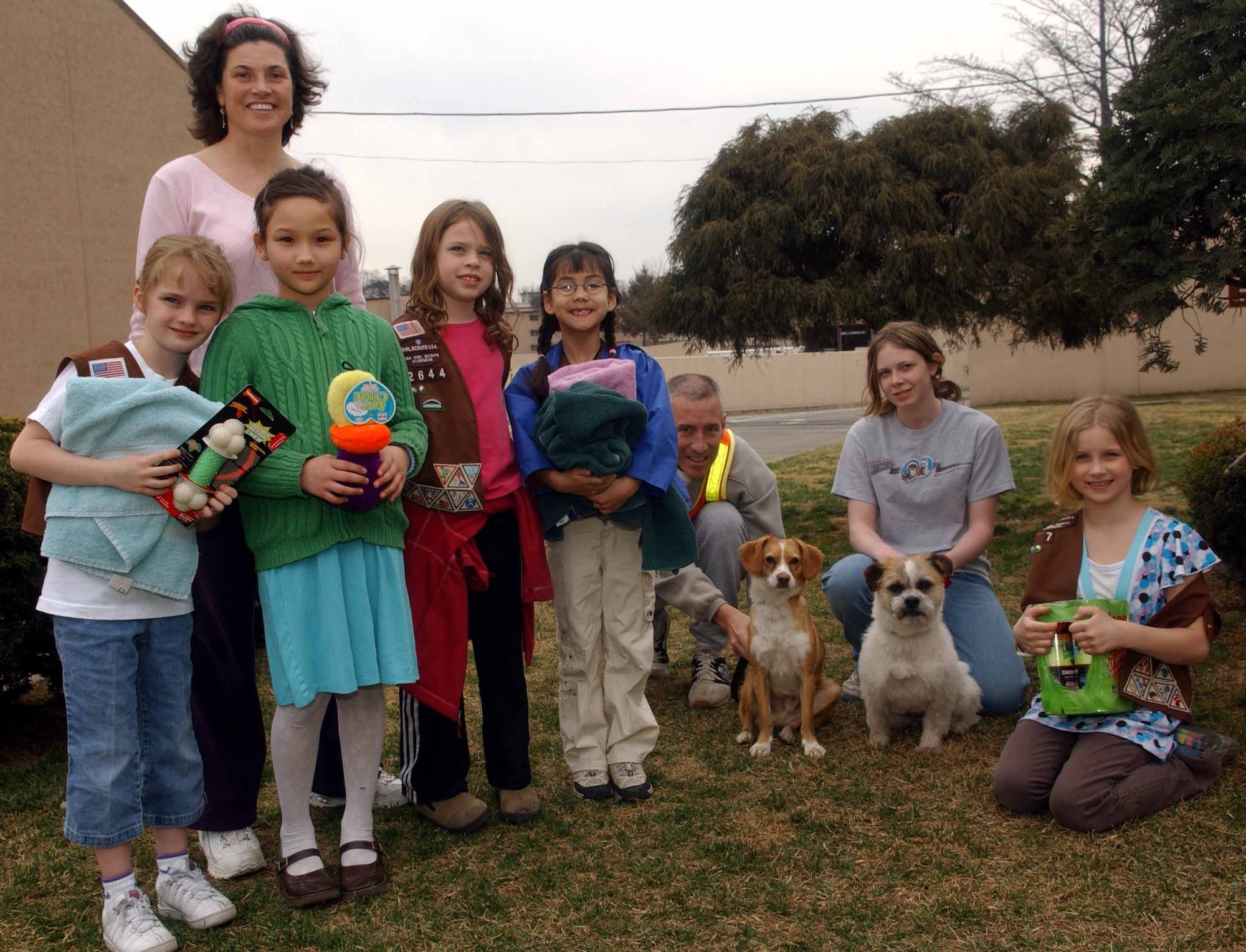 Members of Osan Girl Scout Brownie Troop 7 play with the current residents of the Osan Animal Shelter. The shelter has five female and three male dogs available for adoption.(U.S. Air Force photo/Tech. Sgt. Matt Summers)