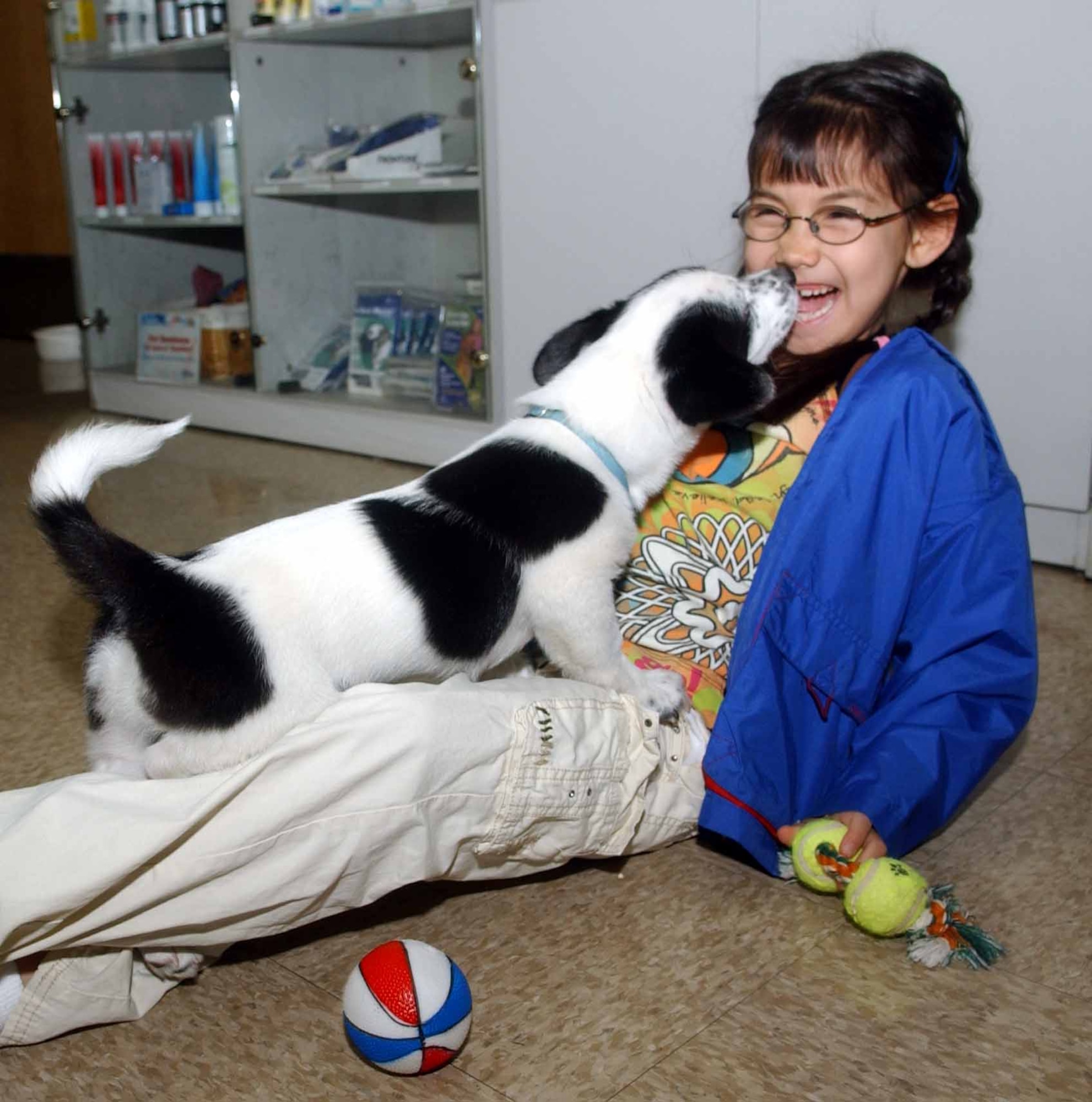 Julia Martinez, a member of Osan Girl Scout Brownie Troop 7, gets a little tender-loving care from Freddie, a 3-month-old resident of the Osan Animal Shelter.(U.S. Air Force photo/Tech. Sgt. Matt Summers)