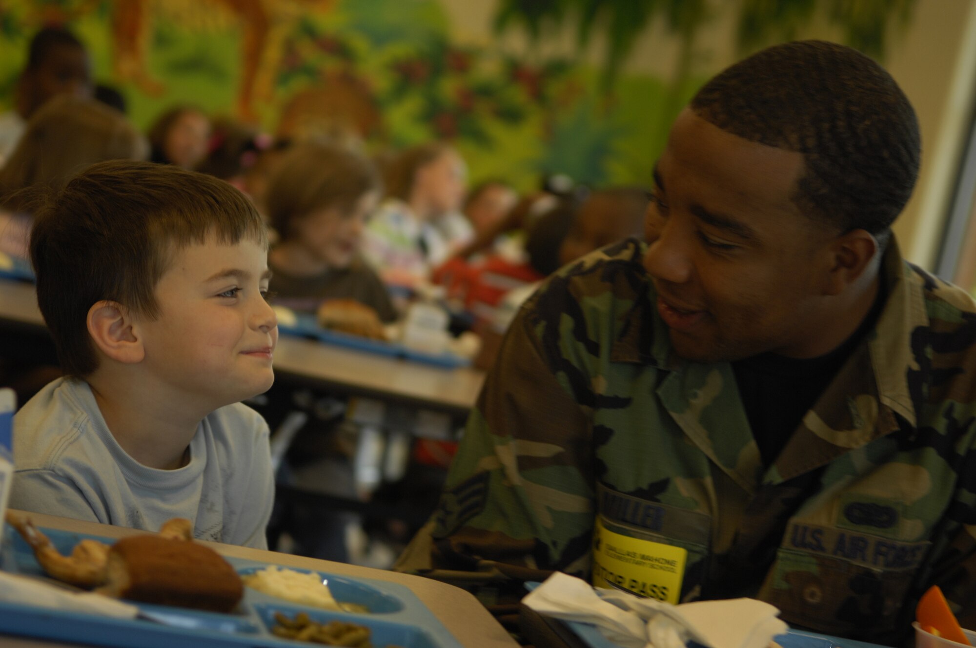 MOODY AIR FORCE BASE, Ga. -- Senior Airman Devin Miller, 23rd Security Forces Squadron unit scheduler, shares a lunch-time conversation with Houston Vanlandingham, a student at Sallas Mahone Elementary School, March 27 as part of the Scott Craven Mentoring Program.  The program was created to provide role-models to children with deployed parents (U.S. Air Force photo by Senior Airman Elizabeth Rissmiller)