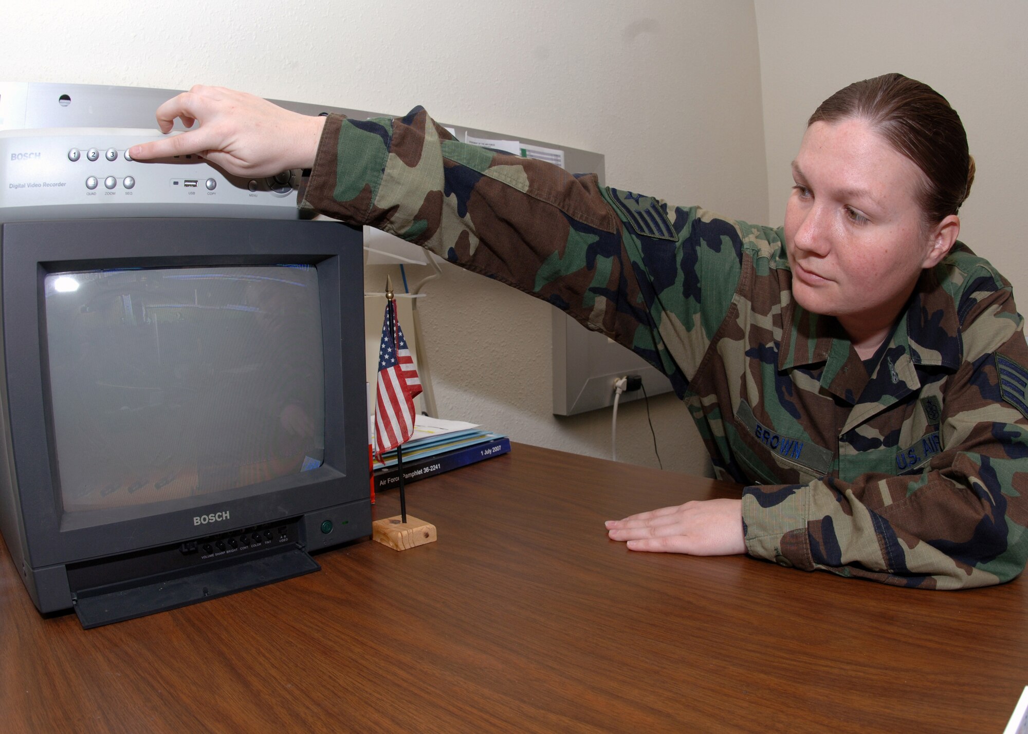 DYESS AIR FORCE BASE, Texas -- Staff Sergeant Cheyanne Brown monitors First Term Airman in a briefing from a hidden camera located in a conference room on the first floor of the First Term Airman Center, Mar. 26. FTAC Airmen are constantly under supervision by their instructors to ensure a strict training environment. (U.S. Air Force Photo by Airman 1st Class Micheal Breaux)