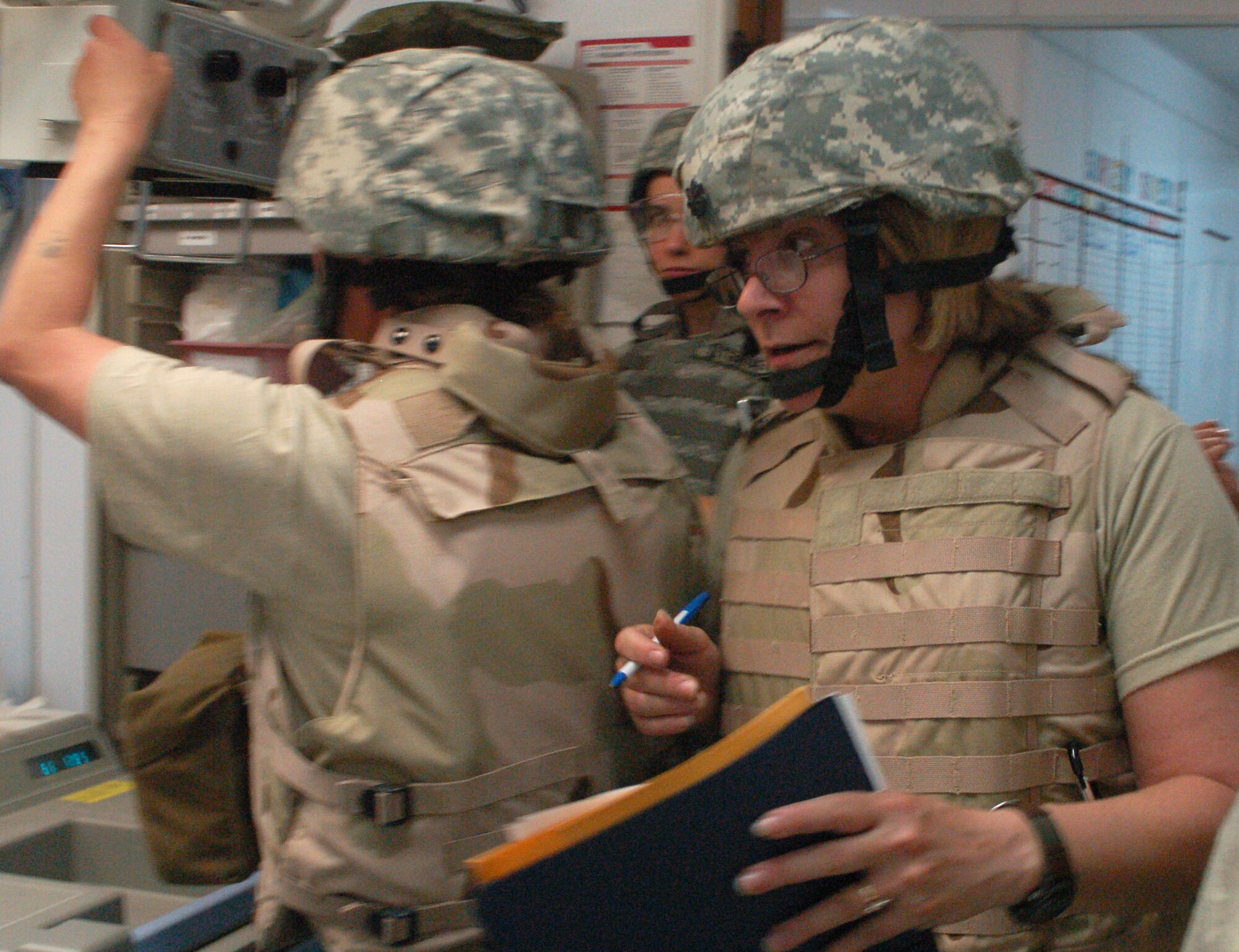 Lt. Col. Patricia Hartman rushes through the organized chaos of the trauma room March 21 at Sather Air Base, Iraq, during a training exercise. The exercise is designed to teach medical skills to non-clinical members. In a combat environment, these procedures can be done by anyone with training, leaving the doctors to tend to the seriously injured. Colonel Hartman is the 447th Expeditionary Medical Squadron's chief administrator.  (U.S. Air Force photo/Tech. Sgt. Amanda Callahan) 
