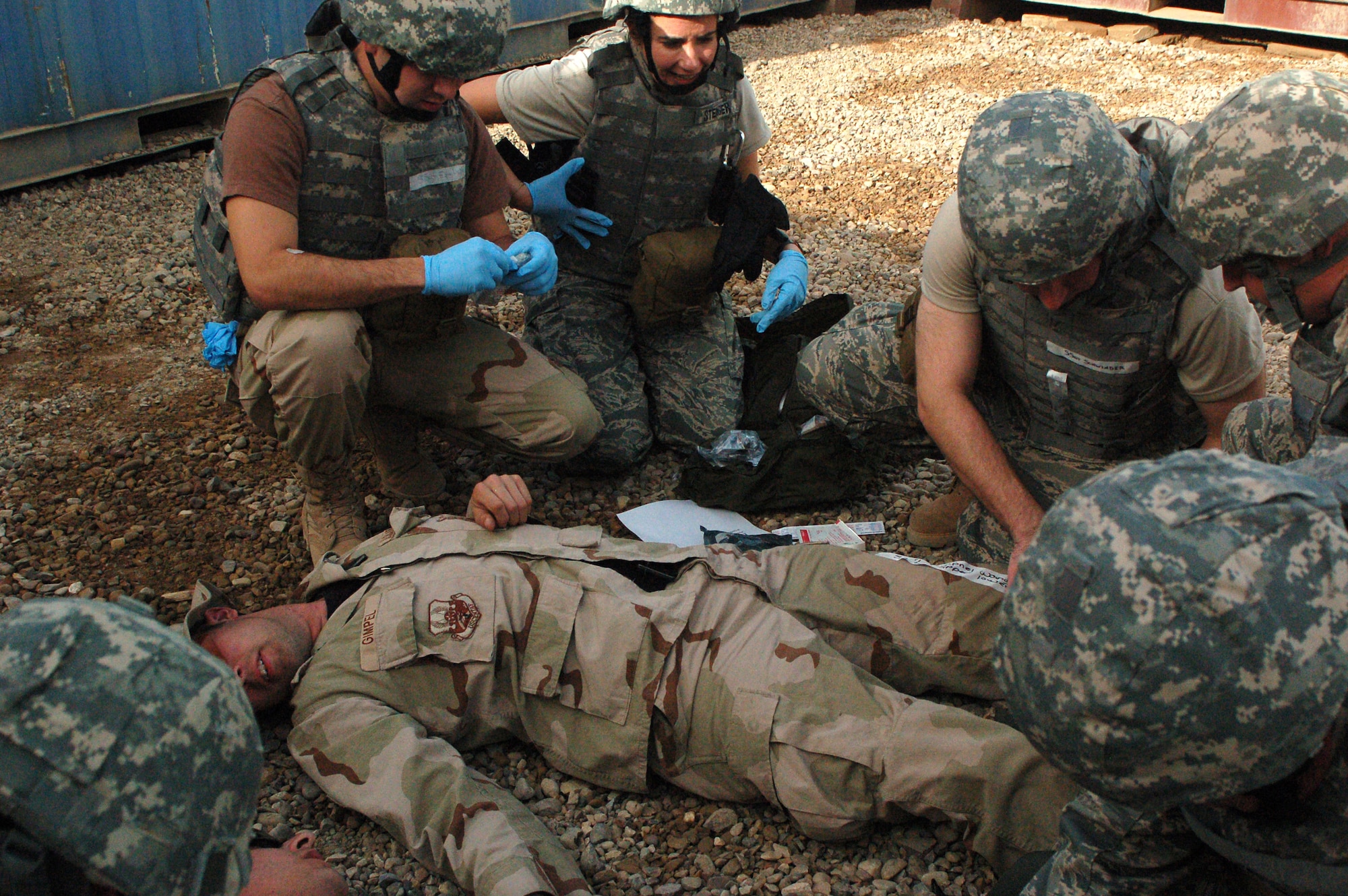 Staff Sgt. Jalayne Powers (left) and Lt. Col. Patricia Hartman assess the simulated injuries of Senior Master Sgt. Michael Brown March 21 at Sather Air Base, Iraq. The injuries are the result of a simulated unexploded oridence detination. The training teaches medical skills to non-clinical unit members. Sergeant Powers is a 447th Expeditionary Medical Squadron bioenvironmental engineer technician. Colonel Hartman is the chief administrator with the 447th EMEDS. Sergeant Brown is the 447th Expeditionary Civil Engineer Squadron's fire department fire chief. (U.S. Air Force photo/Tech. Sgt. Amanda Callahan) 