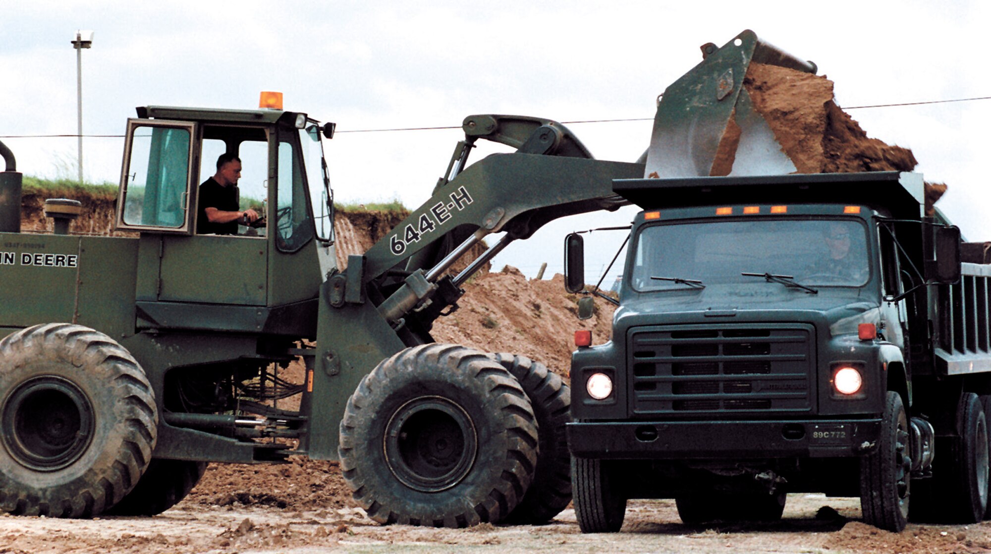 Chief Master Sgt. Stanley Huff, 917th Civil Engineer Squadron, dumps dirt into a dump truck during a 917th Wing Bivouac exercise in June 2000. (U.S. Air Force courtesy photo)
