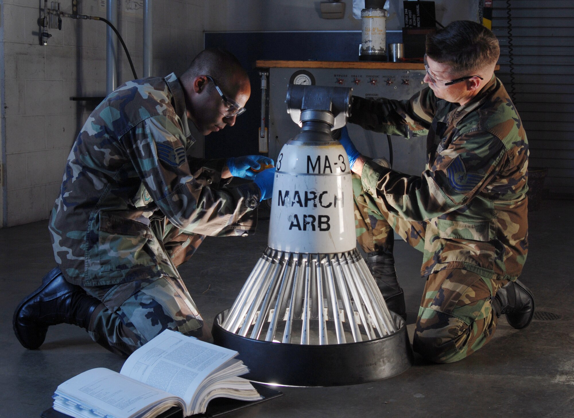 Staff Sgt. Chris Wietecha (left) and Tech. Sgt. Christopher Walls conduct a pressurization test March 25 on a KC-135 Stratotanker aerial refueling drogue.  The sergeants are with the 452nd Maintenance Squadron's aircraft pneudraulics systems shop at March Air Reserve Base, Calif.  March ARB, located in Southern California, is home to the largest air mobility wing in the Air Force Reserve Command. (U.S. Air Force photo/Val Gempis)