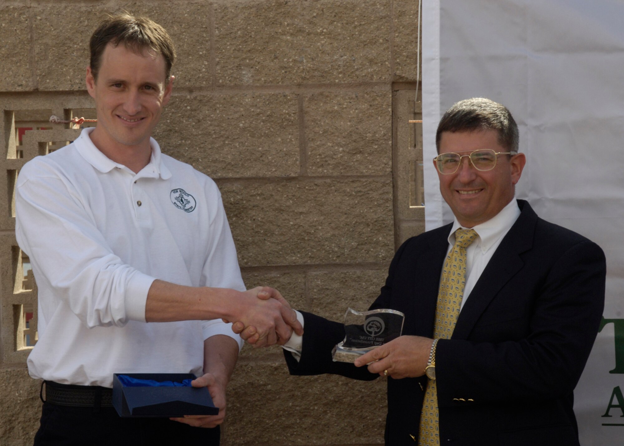 Mr. David Budak, 49th Civil Engineer Squadron deputy base civil engineer is presented a Tree City USA plaque by Mr. Lance Davisson, New Mexico State Urban and Community Forestry program manager March 26, 2008, at Holloman Air Force Base, N.M. Holloman celebrated the trees on the base's living environment and the retention of the designation "Tree City USA". (U.S. Air Force photo/Airman 1st Class Michael J. Means)
