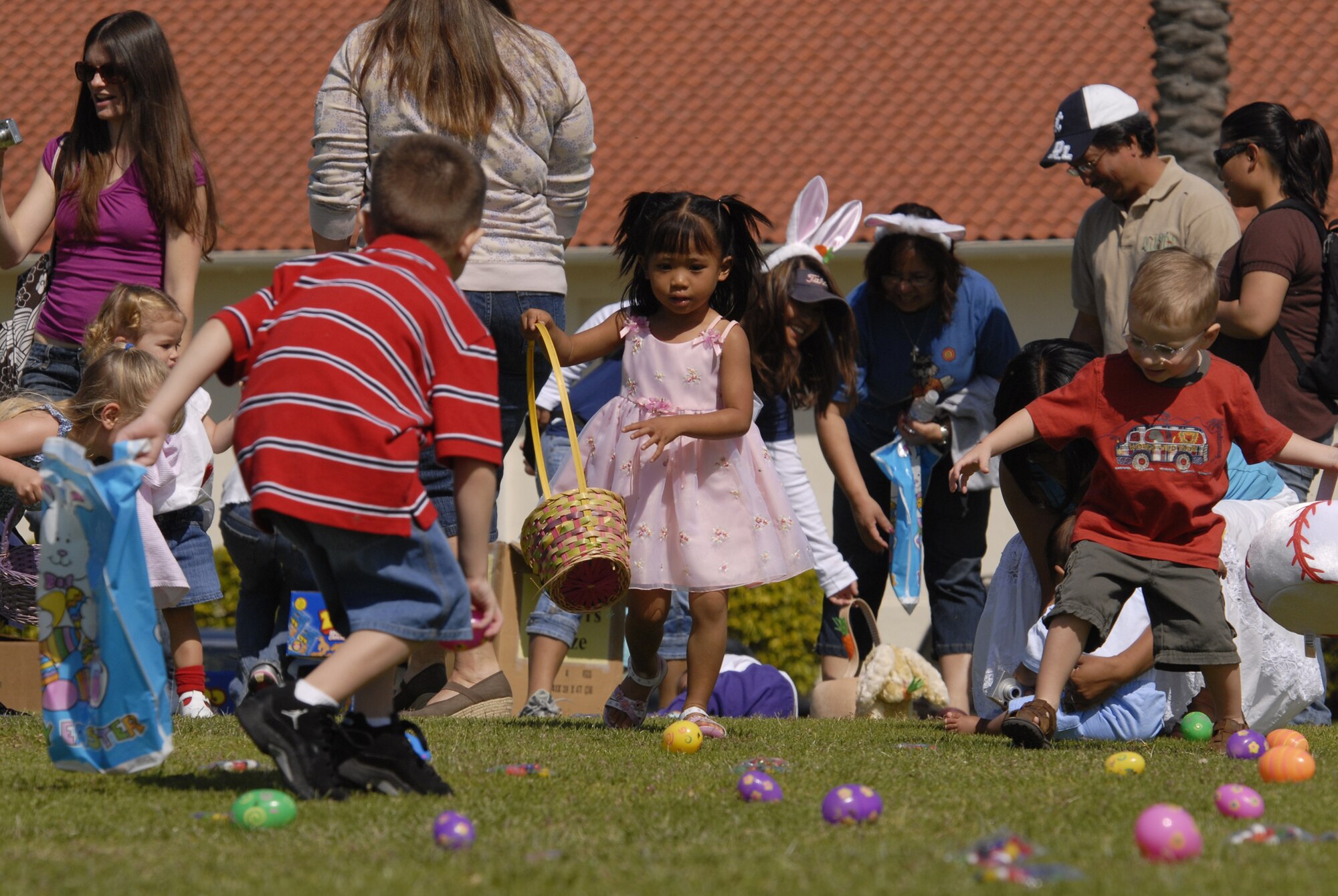 Children scramble for Easter eggs during the annual egg hunt on Fort MacArthur, March 22. A petting zoo, magic show, Easter egg hunt and visit from the Easter Bunny were all part of the festivities. (Photo by Joe Juarez)