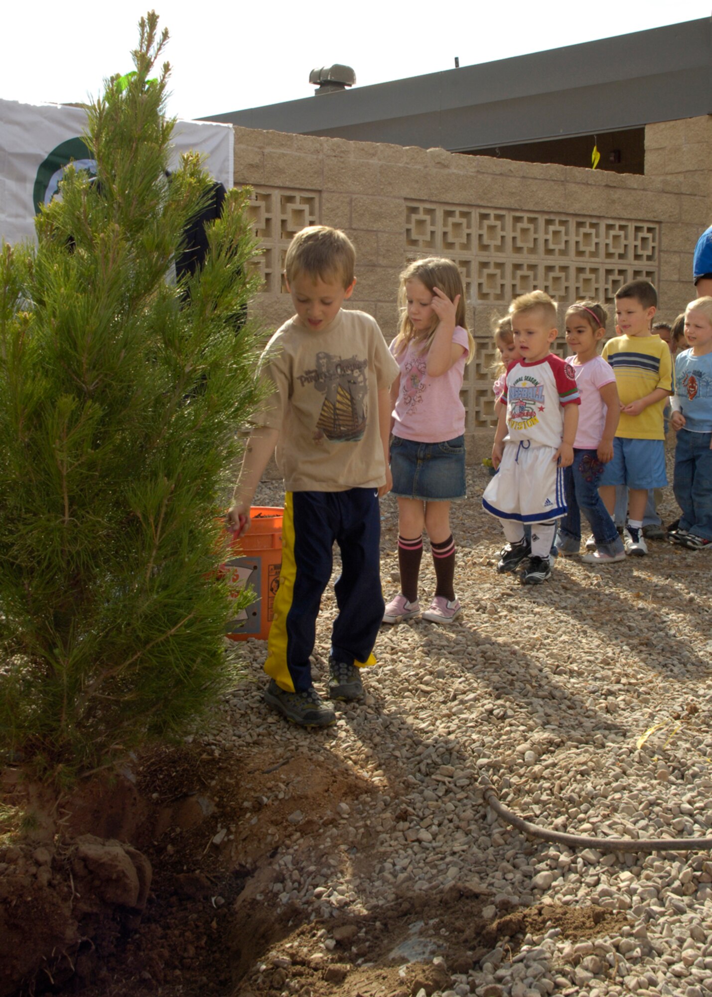 Children from the Child Development Center on Holloman Air Force Base, N.M., plant a tree March 26, 2008. Holloman celebrated the trees on the base's living environment and the retention of the designation "Tree City USA". (U.S. Air Force photo/Airman 1st Class Michael J. Means)