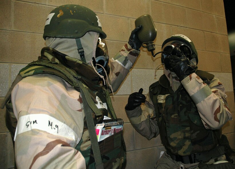 (Left to right) Master Sgt. Daniel Schultz, 46th Aerial Port Squadron, helps Master Sgt. Louis Camphor, 46th APS, drink water during an exercise March 18 in Alpena, Mich. The “buddy concept” is a life-saving mindset Airmen must adopt to survive in a hostile environment. (U.S. Air Force photo by Master Sgt. Melissa Phillips)