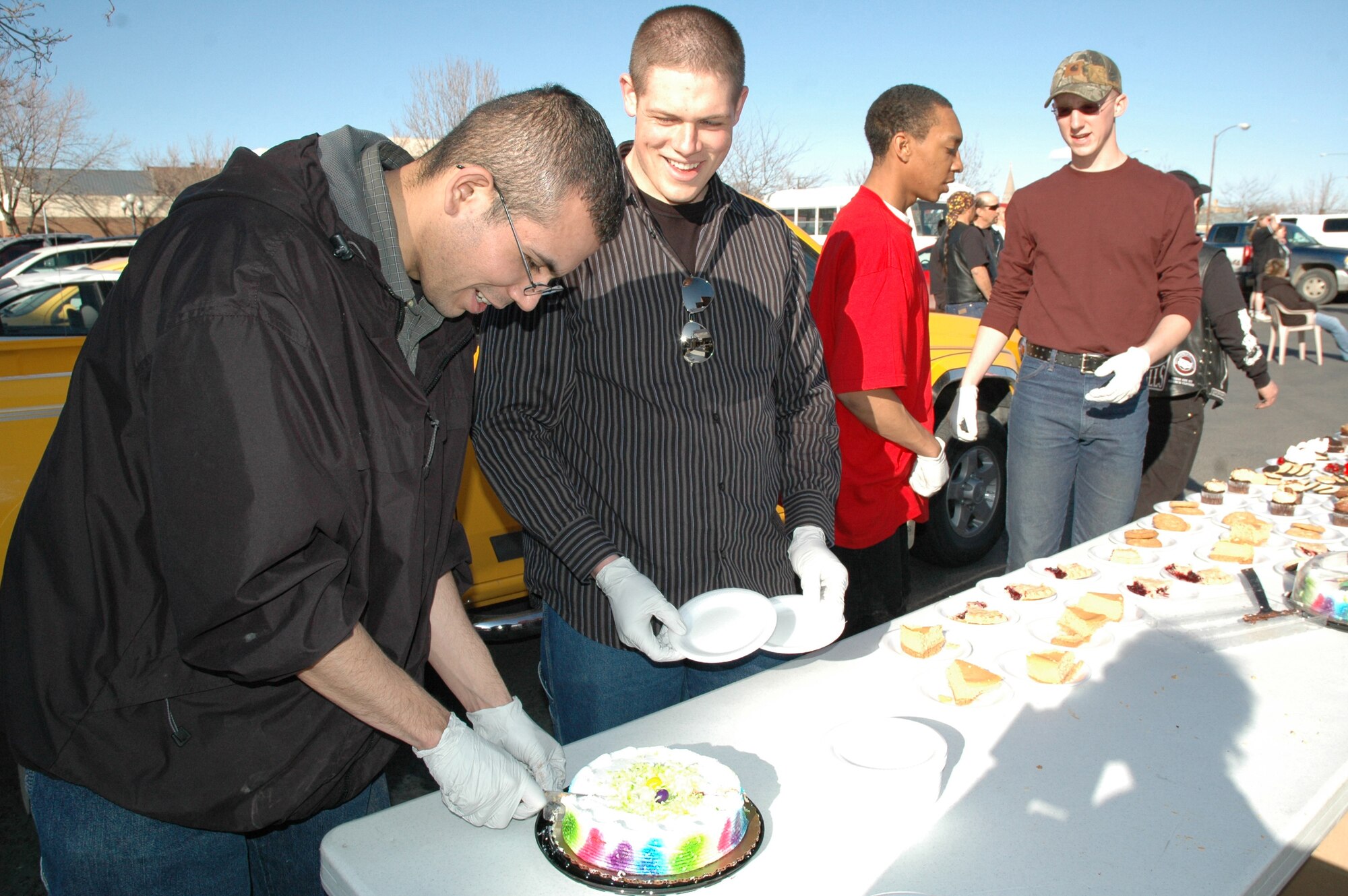 2nd Lt. Jose Hernandez and Airman 1st Class Aurie Pennington, 341st Civil Engineer Squadron, cut desserts during a cook-off for homless and needy members of the Great Falls community. The cook-off was held March 22 and was followed by an Easter service sponsored by the Servants for Christ. They will be holding a cook-off each Saturday through summer starting at 5 p.m. at the corner of 1st Ave. N and 6th St.  Individuals interested in volunteering can contact JT Coughlan at 453-4479. (U.S. Air Force photo/Airman 1st Class Emerald Ralston)