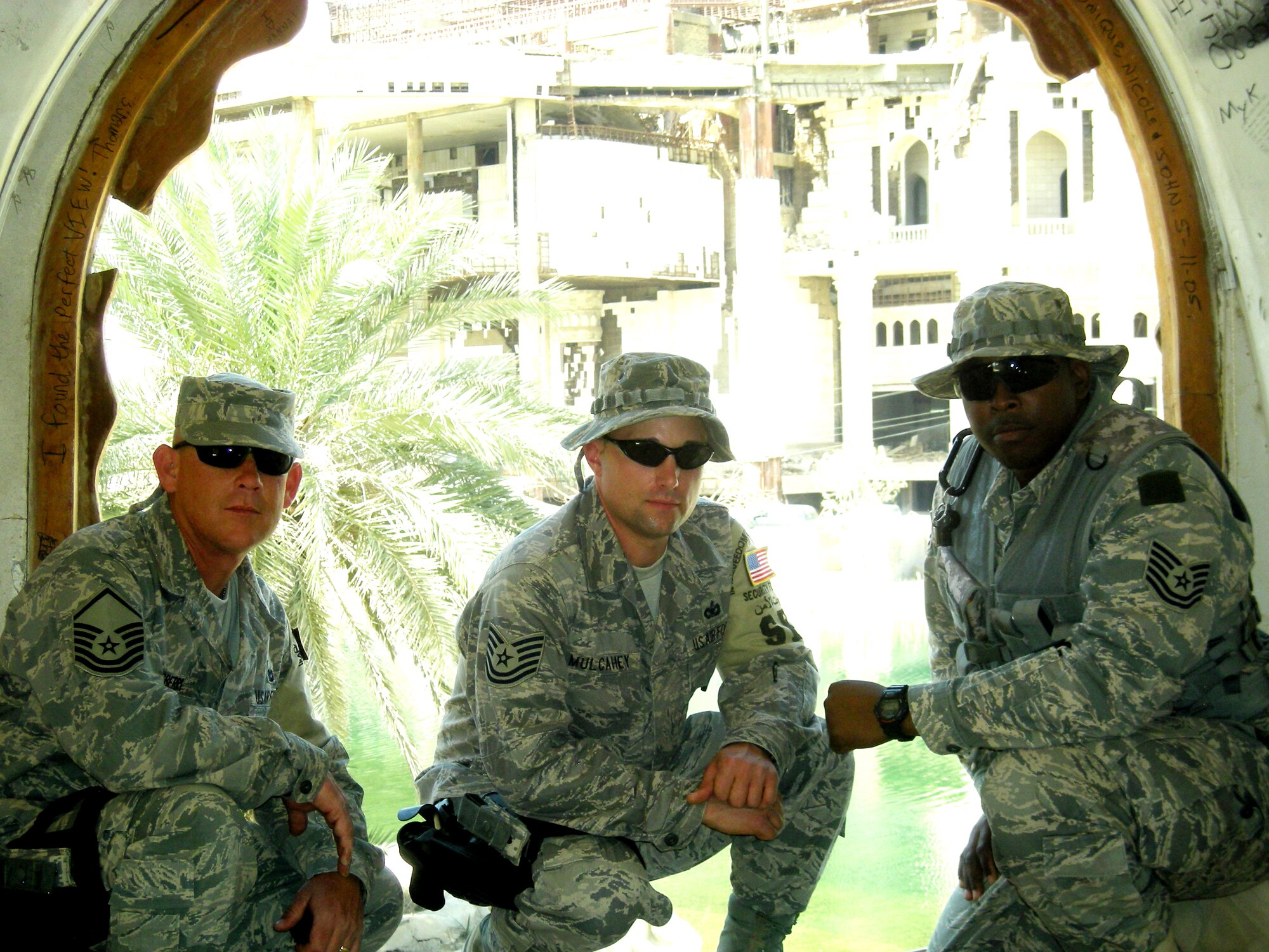 (From left to right) Master Sgt. Jeff Thornsberry, Tech. Sgt. James Mulcahey and Tech. Sgt. Dion Hawkins pause to take a photo near remnants of the former Iraqi regime in Baghdad, Iraq. The three Guardsmen deployed with 16 other 162nd Security Forces Squadron members to Baghdad International Airport for a voluntary six-month tour of duty which began Feb. 24. The Guardsmen, who provide full-time security for the 162nd, now use their training and expertise to secure Iraq’s largest airport. They are scheduled to return to Tucson in September. (Air National guard Photo)