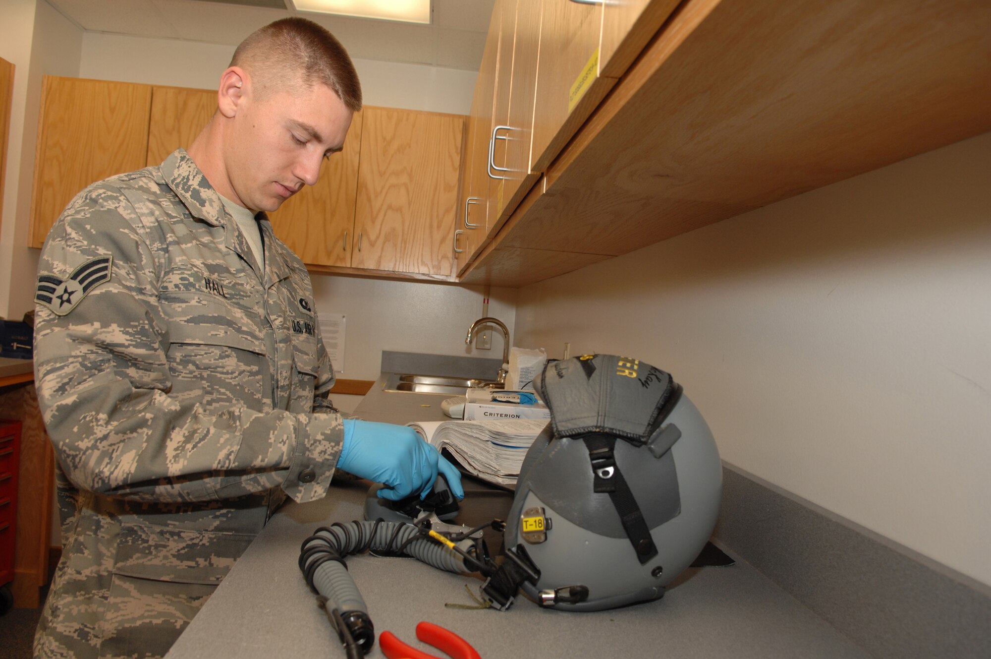 WHITEMAN AIR FORCE BASE, Mo. - Senior Airman Erick Hall, 393rd Bomb Squadron, Aircrew Flight Equipment specialist inspects a MBU20/P mask. Masks are inspected every 30 days for damage. Aircrew Flight Equipment Specialist’s are capable of making repairs to equipment as needed.  (U.S. Air Force Photo/ Senior Airman Jessica Snow)