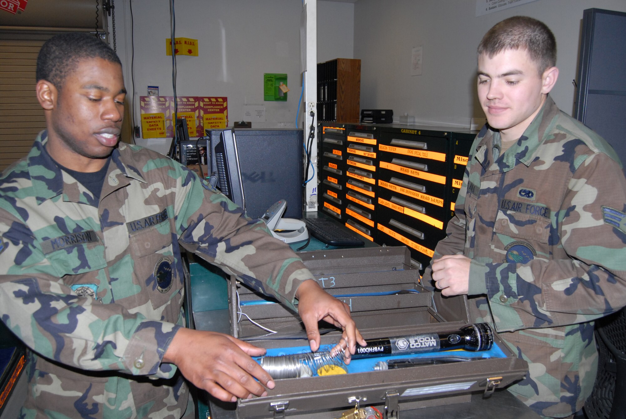 (Left) Airman 1st Class Dennis Morrison, 43rd Aircraft Maintenance Squadron, returns a toolbox as Senior Airman Juan De Avila, 43rd Maintenance Squadron, makes sure all items are in the box March 24. Airman Morrison used the toolbox to service a hyrdraulic problem on an aircraft.  (U.S. Air Force Photo by 2nd Lt. Chris Hoyler)