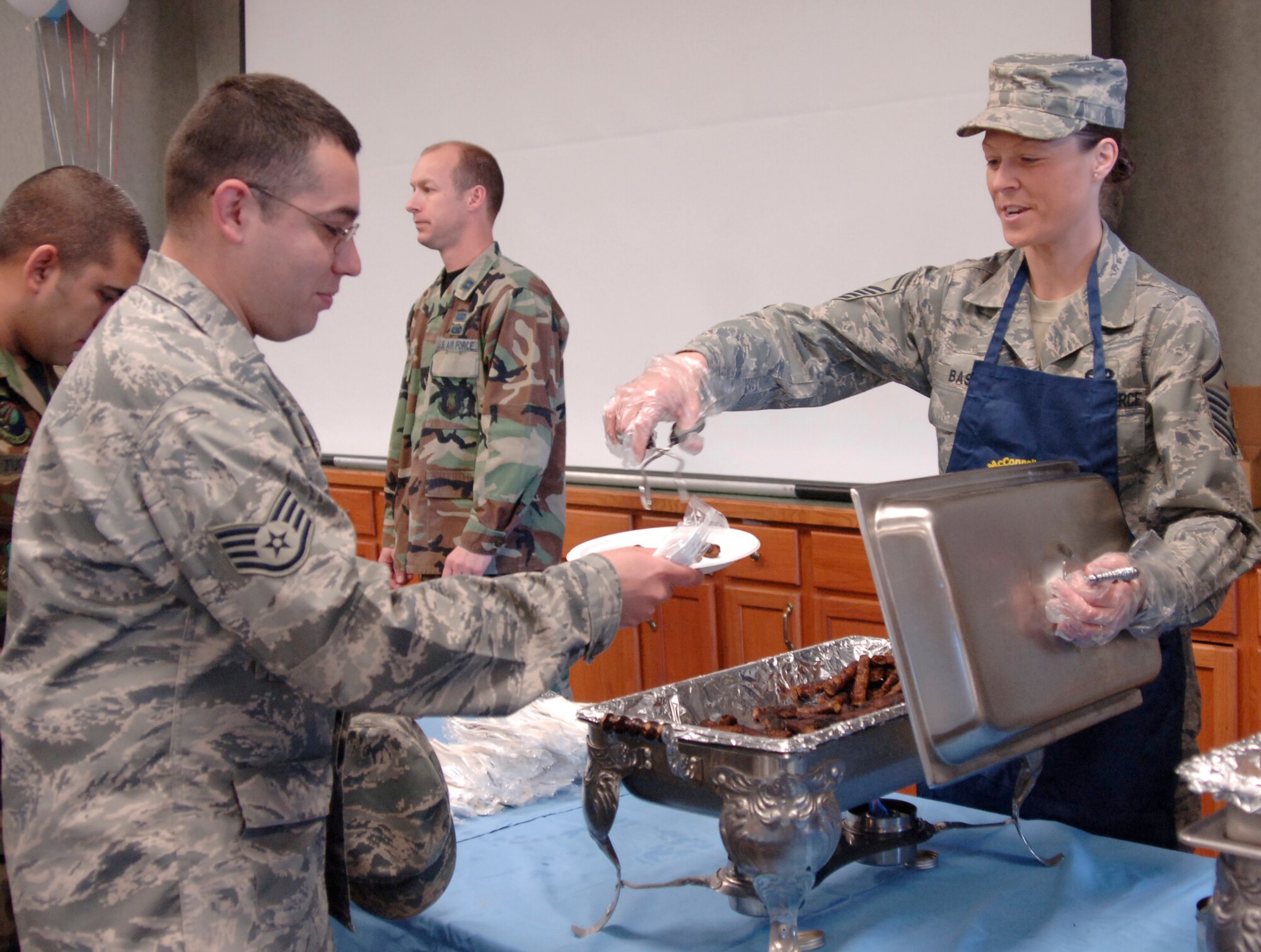 MCCONNELL AIR FORCE BASE, Kan. – Staff Sgt. Kyle Thomas, 22nd Logistics Readiness Squadron prepares his pancakes at an Air Force Assistance Fund campaign breakfast fundraiser hosted by the first sergeant’s council March 25, at the base Chapel Annex. The AFAF was established to provide for an annual effort to raise funds for charitable affiliates that provide support to the Air Force family. (Photo by Senior Airman Roy Lynch III)