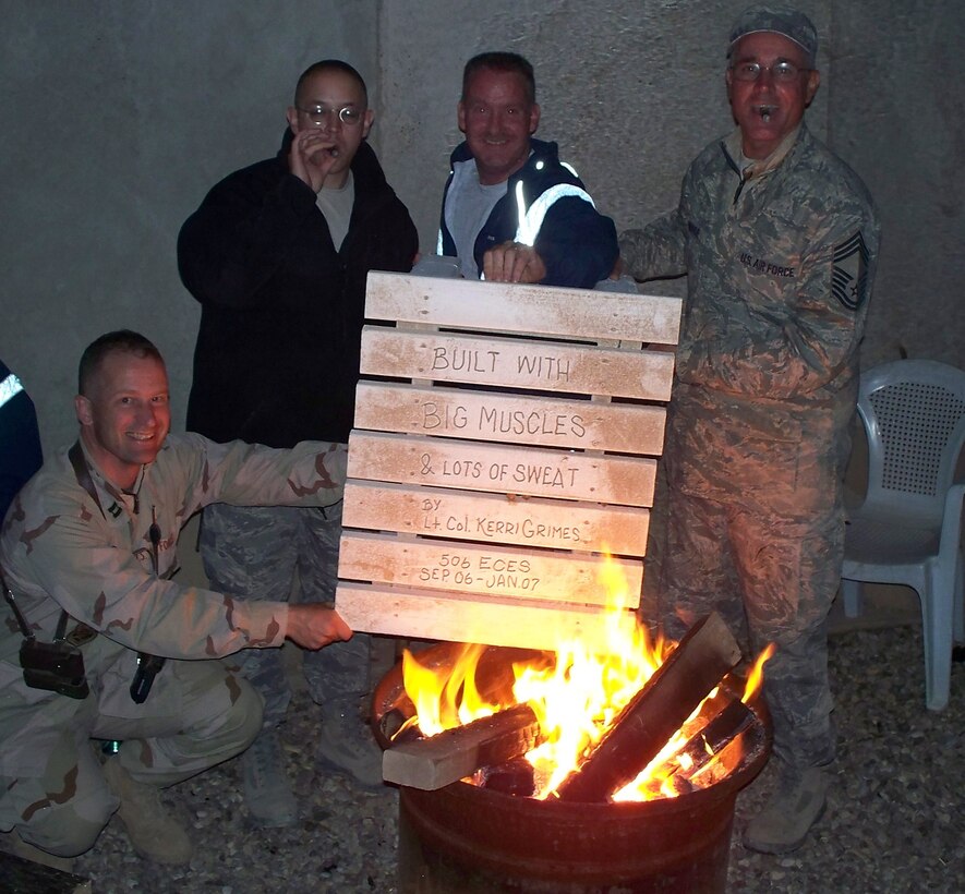 SEYMOUR JOHNSON AIR FORCE BASE, N.C. -- From left to right: Capt. Chris Woofter, Capt. Jason Moschella, Master Sgt. John Hahn and Chief Master Sgt. Willis Donohue poke a little fun at their 916th Civil Engineer Commander Lt. Col. Kerri Grimes. The four reservists are currently deployed to Kirkuk, Iraq and pretend to destroy a table top made by Lt. Col. Grimes during her deployment to the same location in 2007.